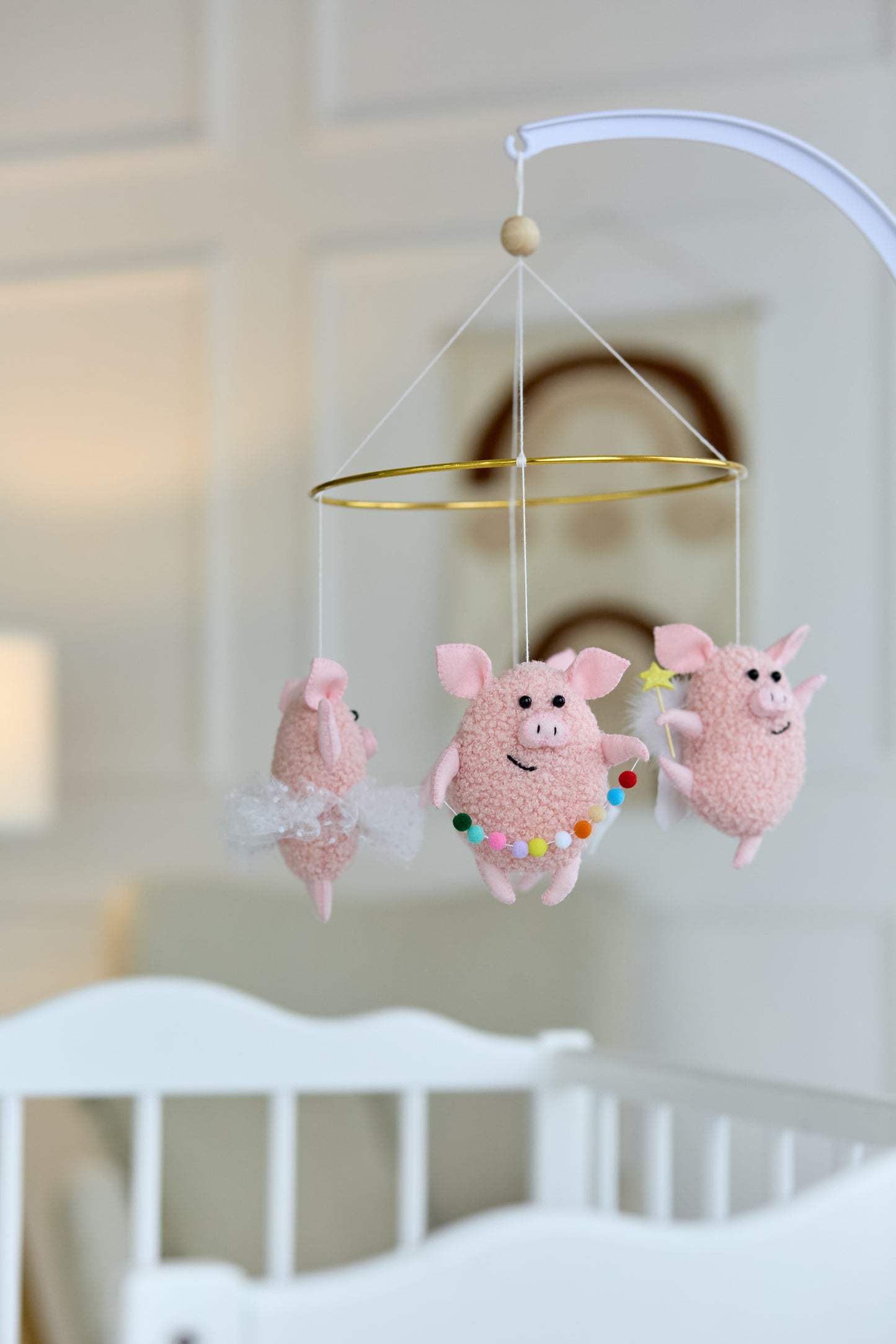 Nursery crib mobile with animals in neutral pink colors
