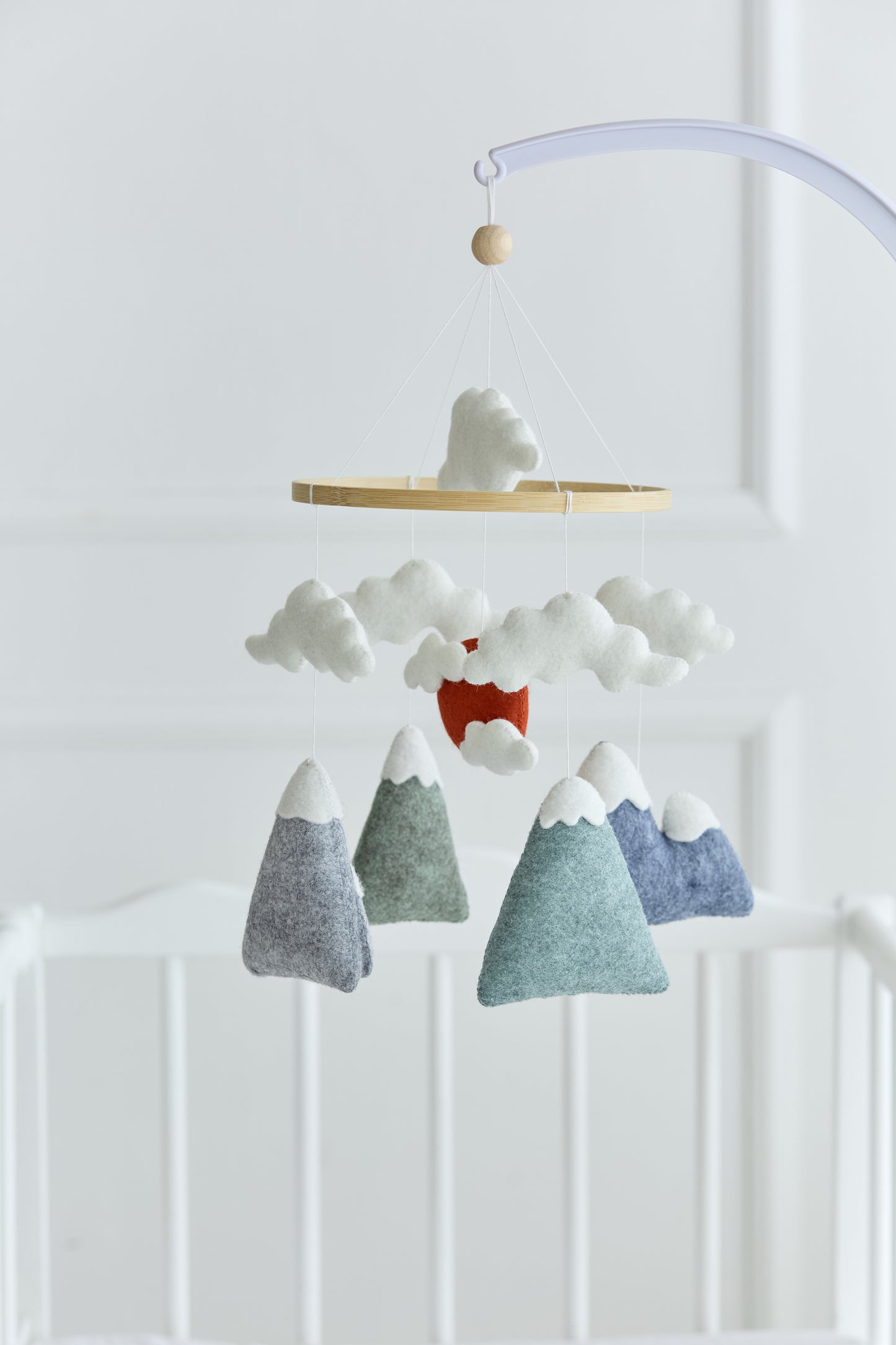 Handmade baby mobile with clouds and wooden hoop