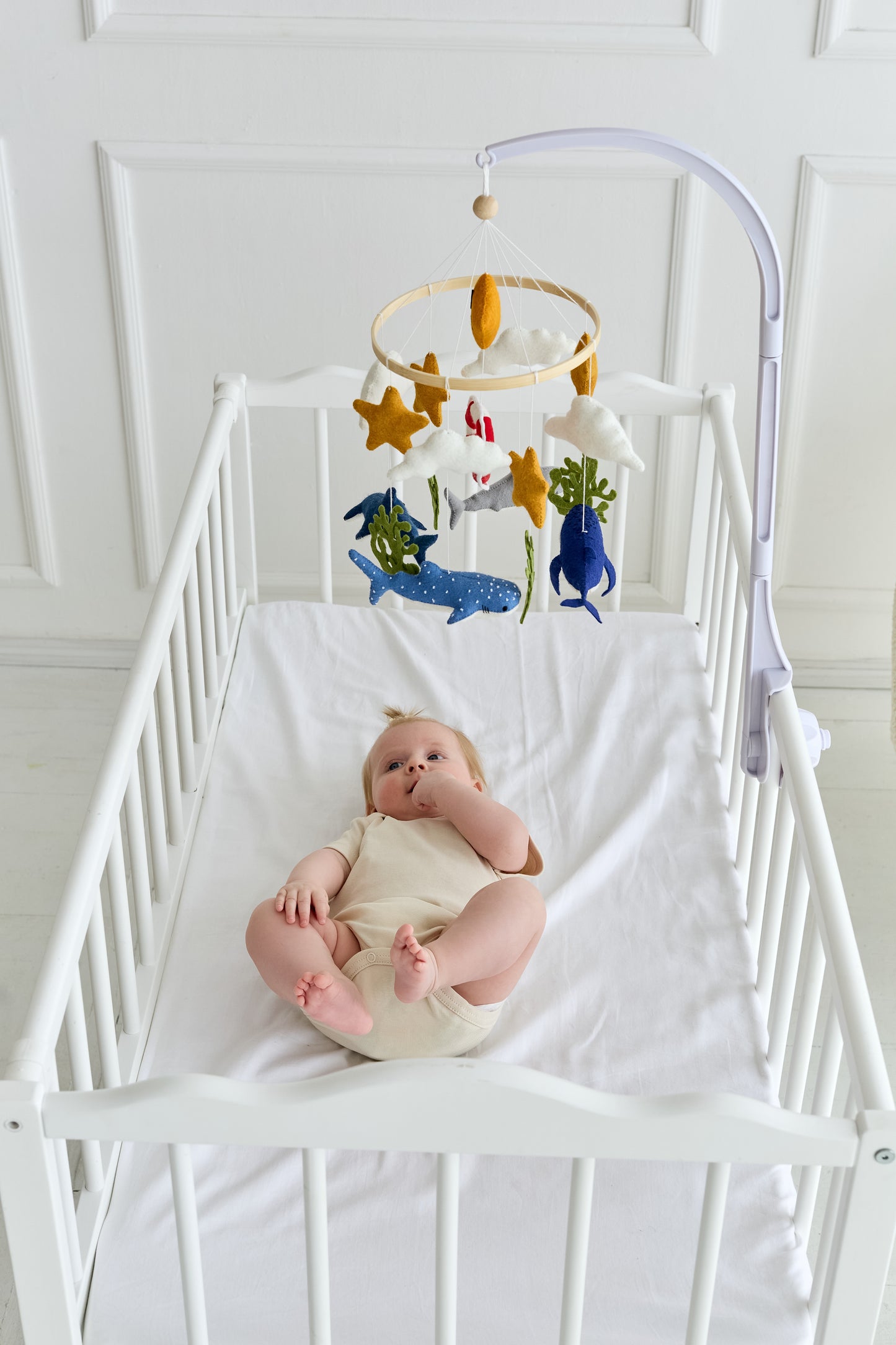 Coastal-themed baby crib mobile with music box option