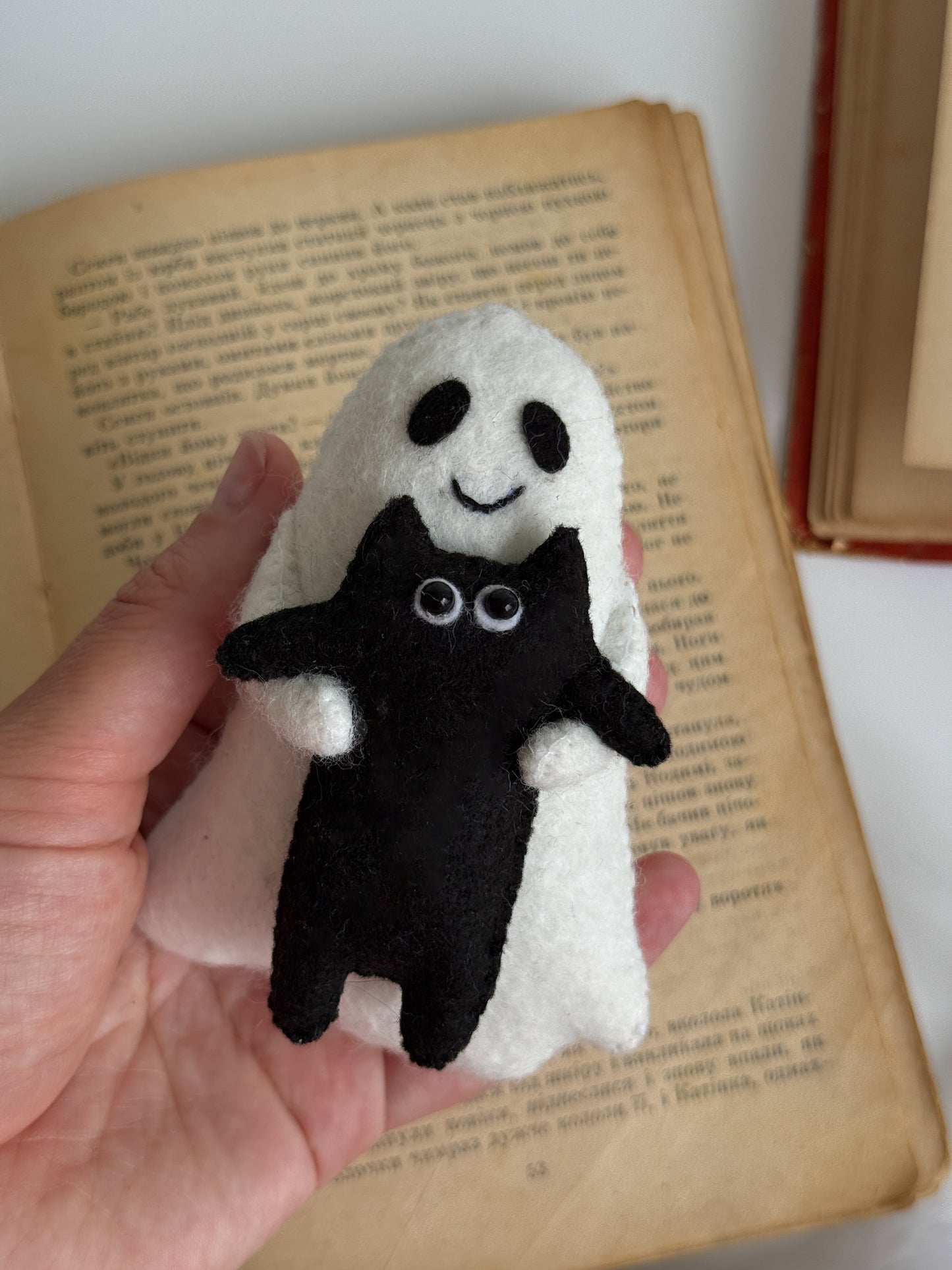 Close-up of spooky cute felt ghost with cat