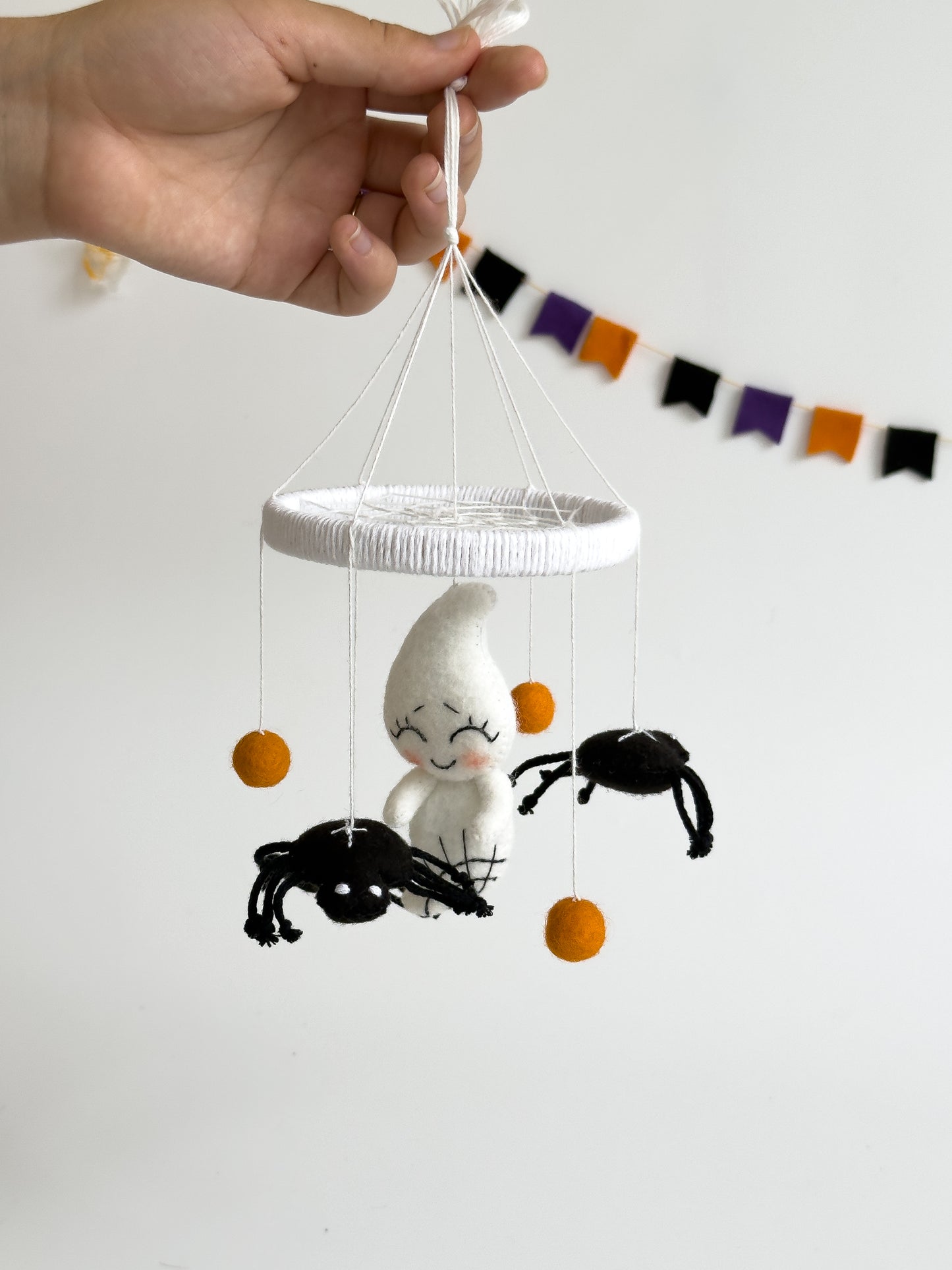 . Felt ghost baby mobile with orange felt balls