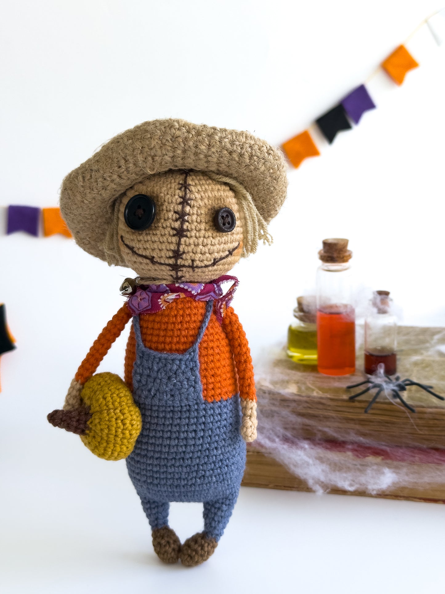 Handmade crochet scarecrow with mini pumpkin and straw hat