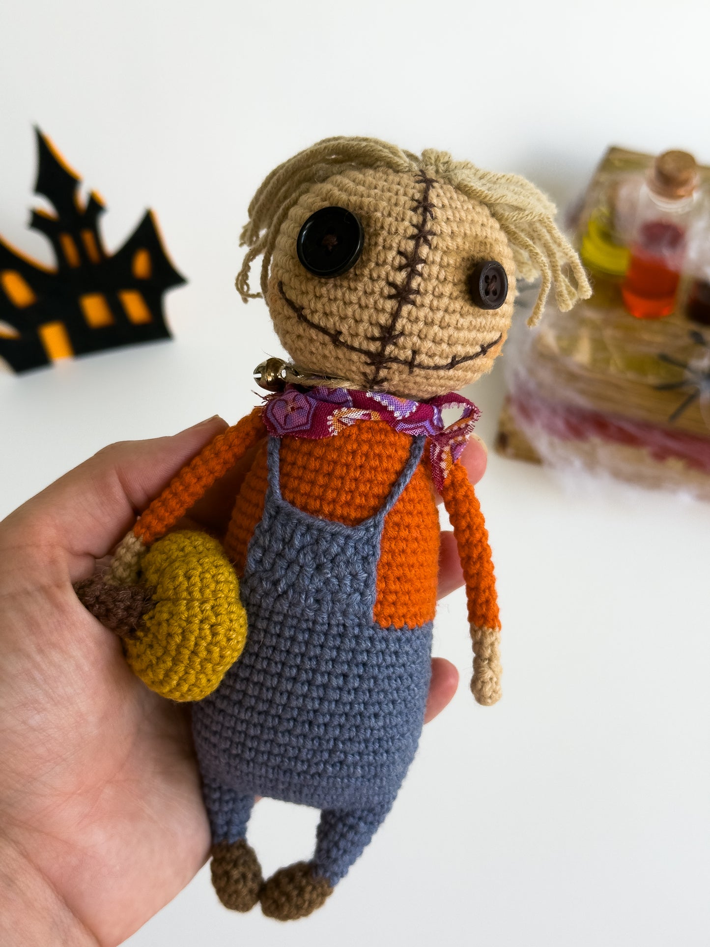 Handmade crochet scarecrow with mini pumpkin and straw hat