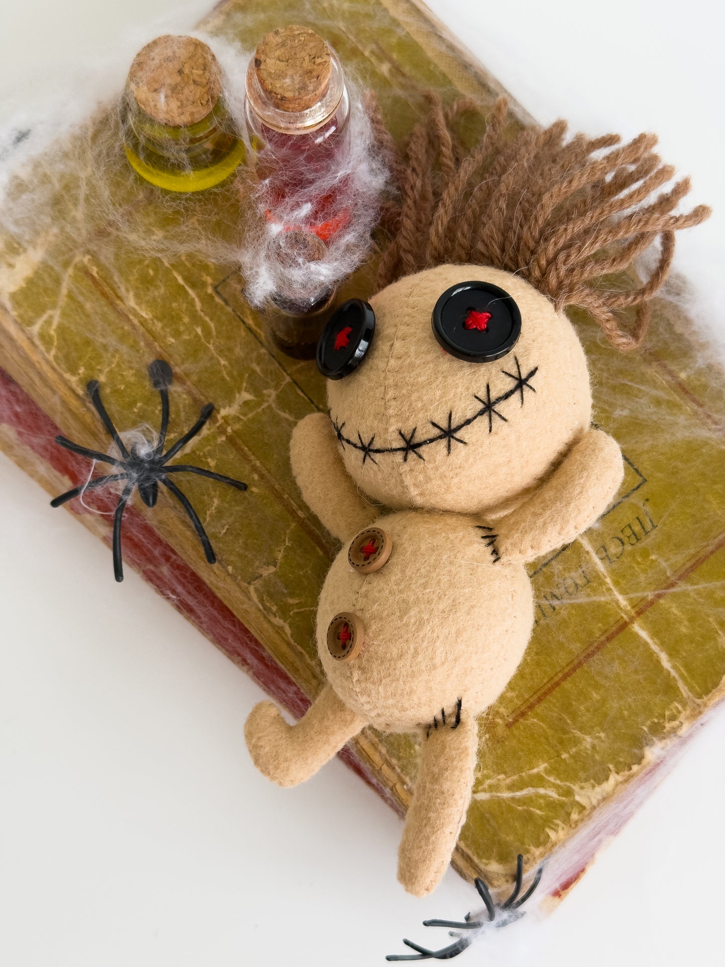 Creepy cute voodoo felt doll with button eyes and yarn hair