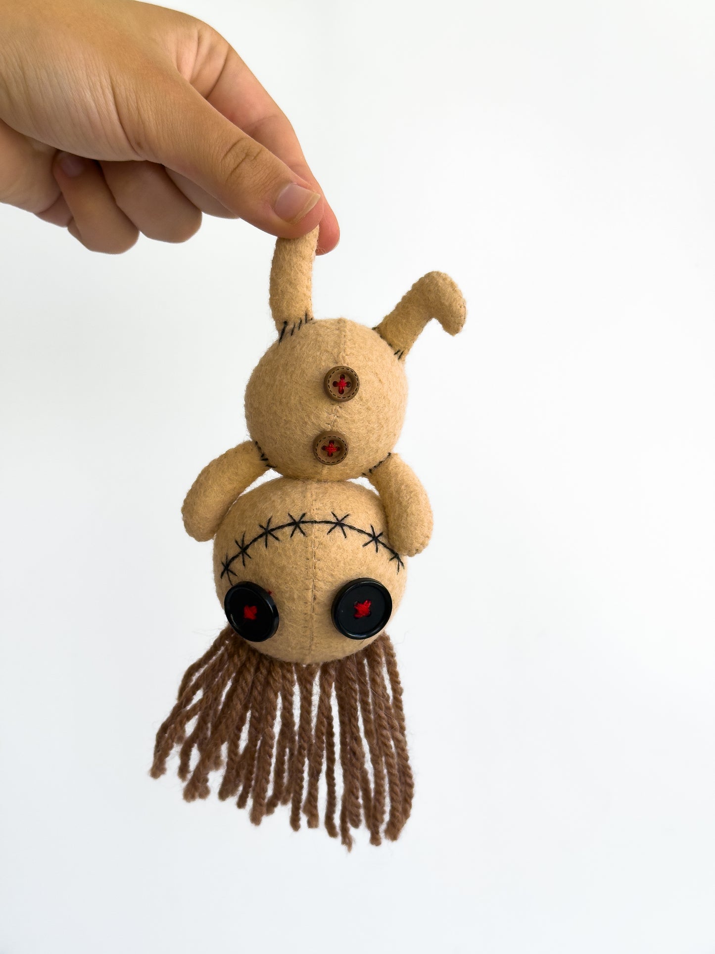 Creepy cute voodoo felt doll with button eyes and yarn hair