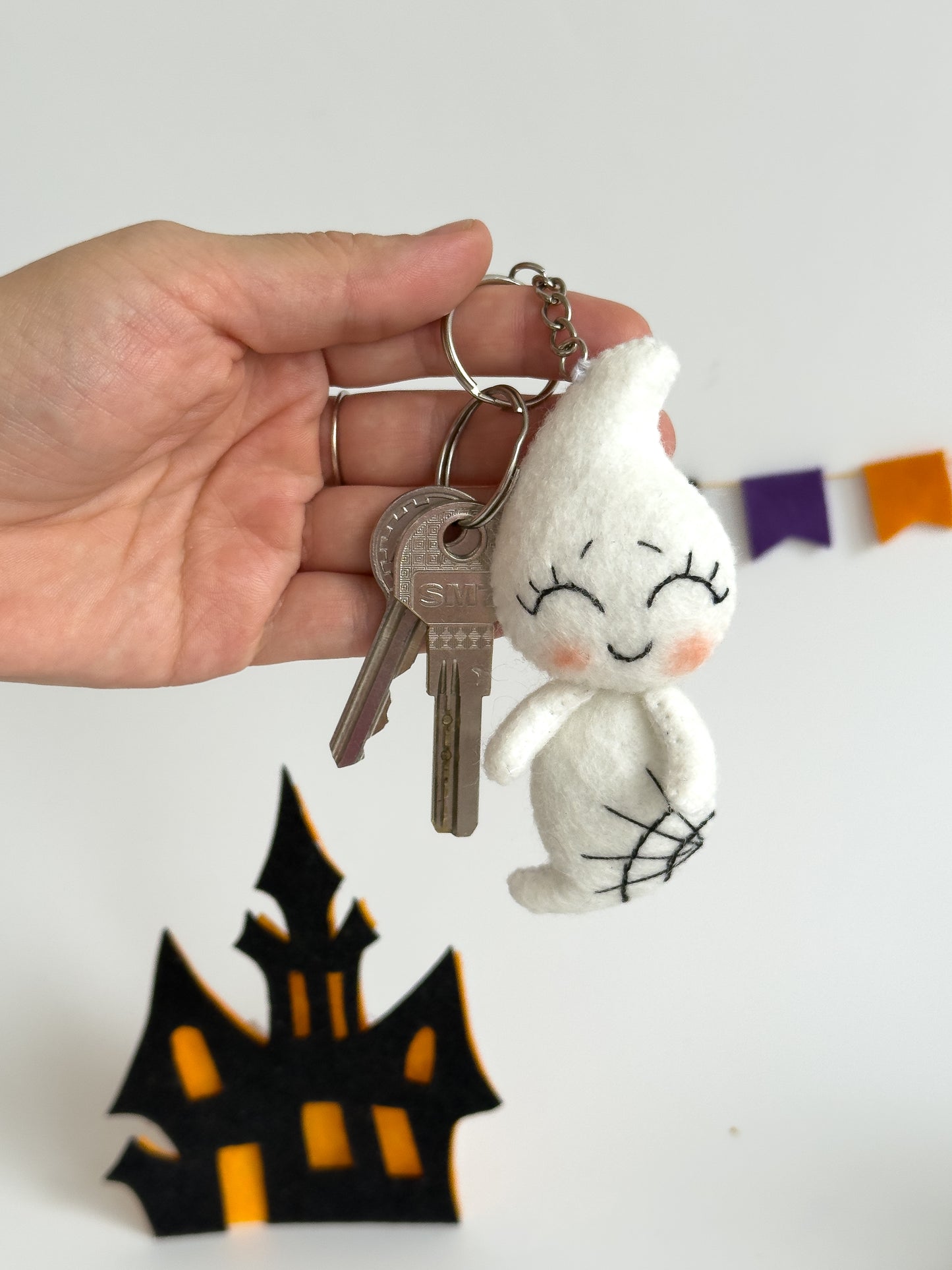 Handmade felt ghost keychain with smiling face