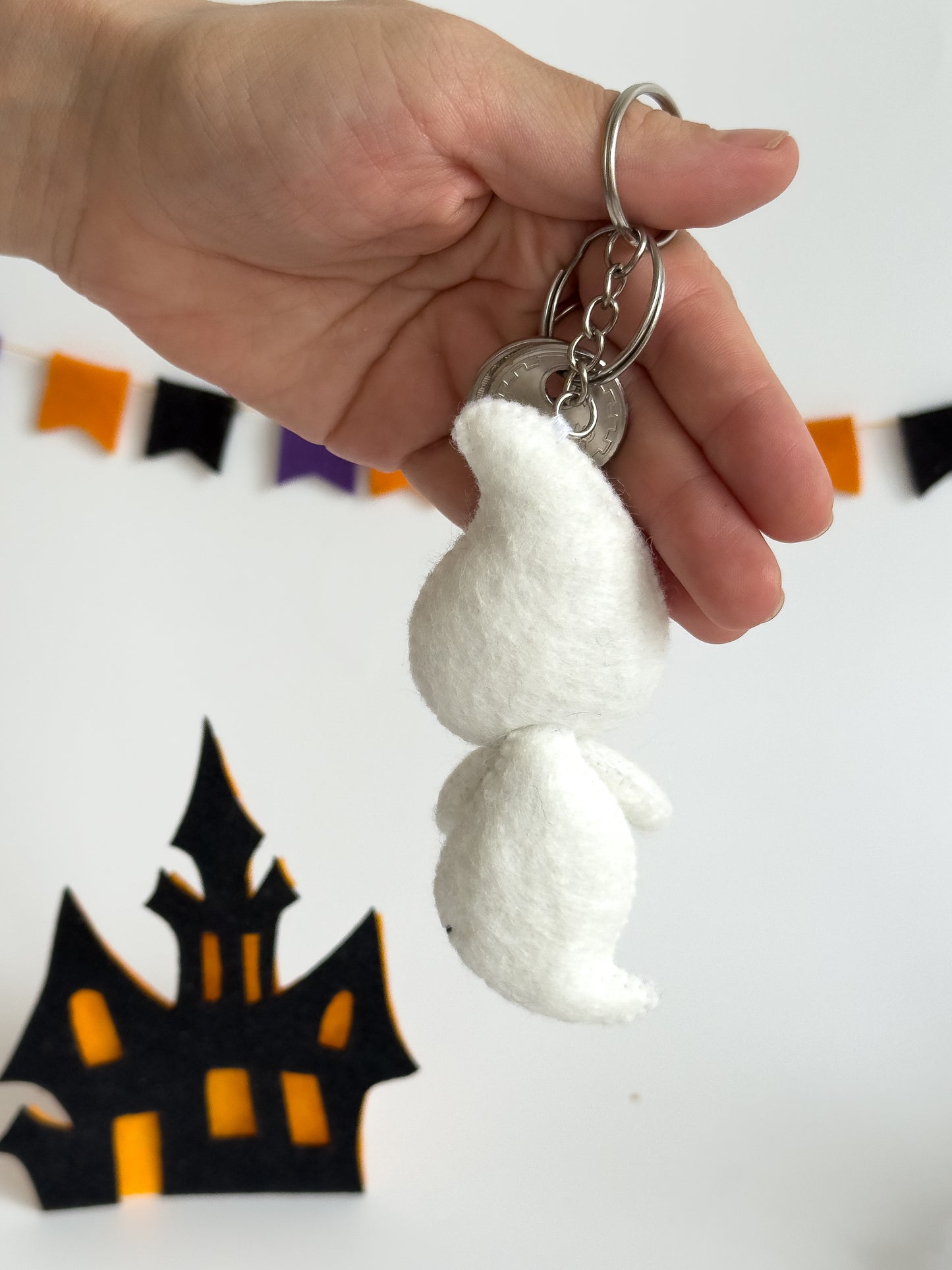 Ghost keychain in hand with keys attached