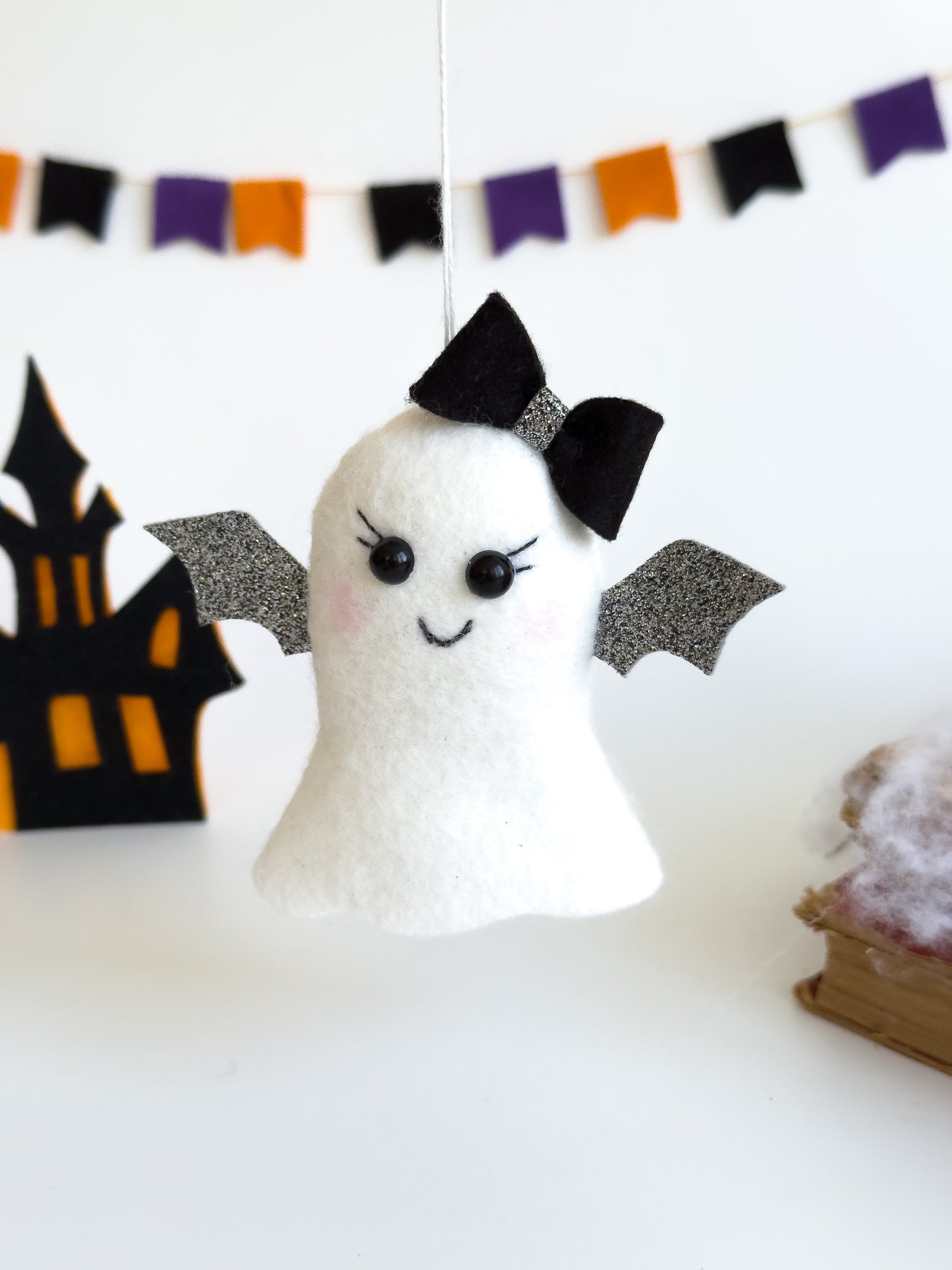 Handmade felt ghost ornament with silver glitter wings and bow