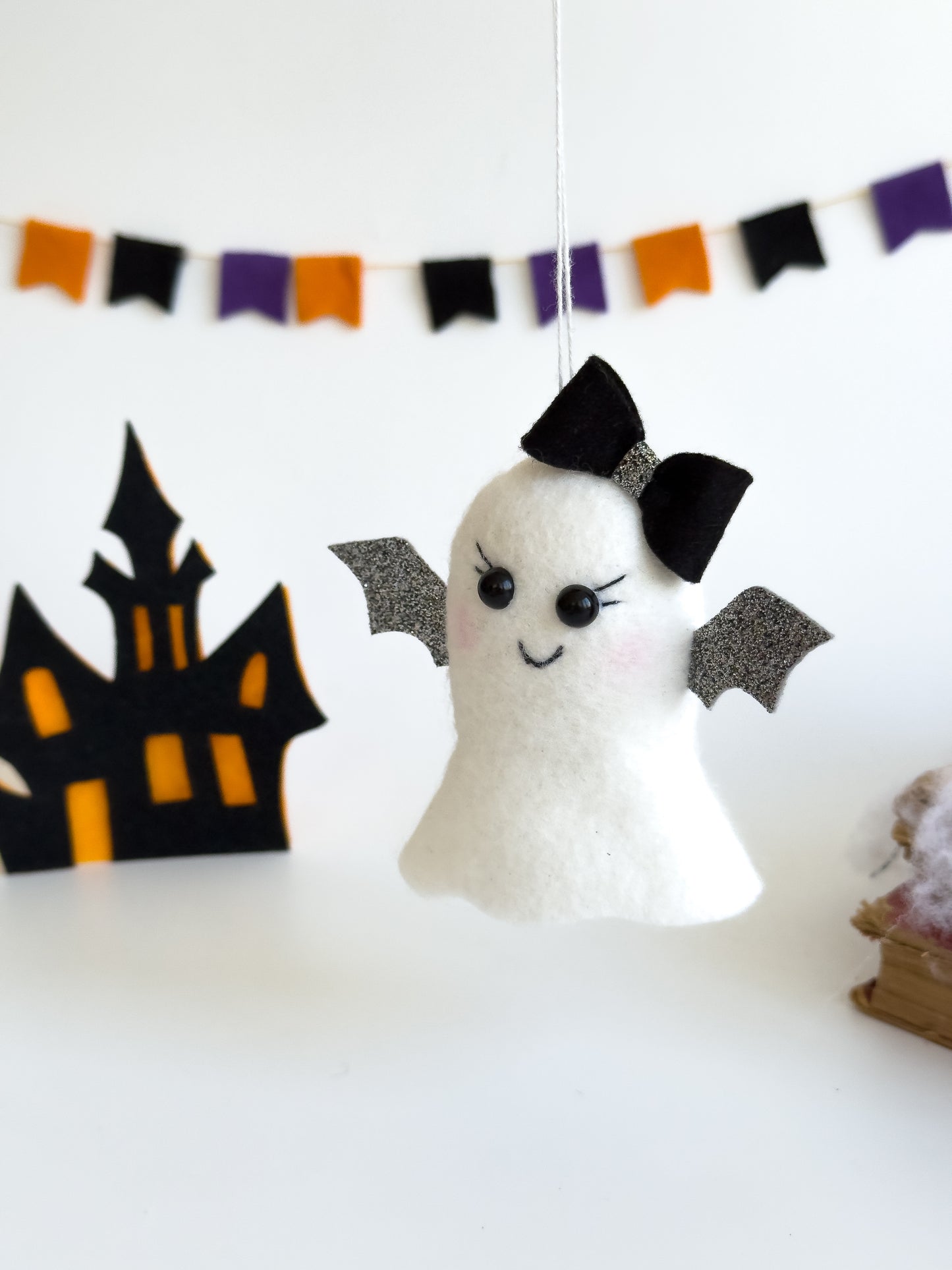 Handmade felt ghost ornament with silver glitter wings and bow