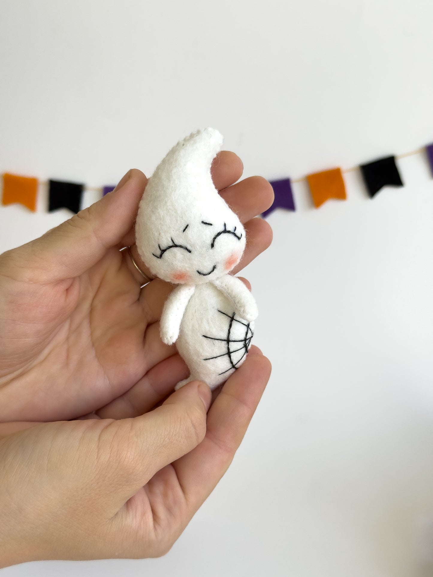 Handmade felt ghost keychain with smiling face