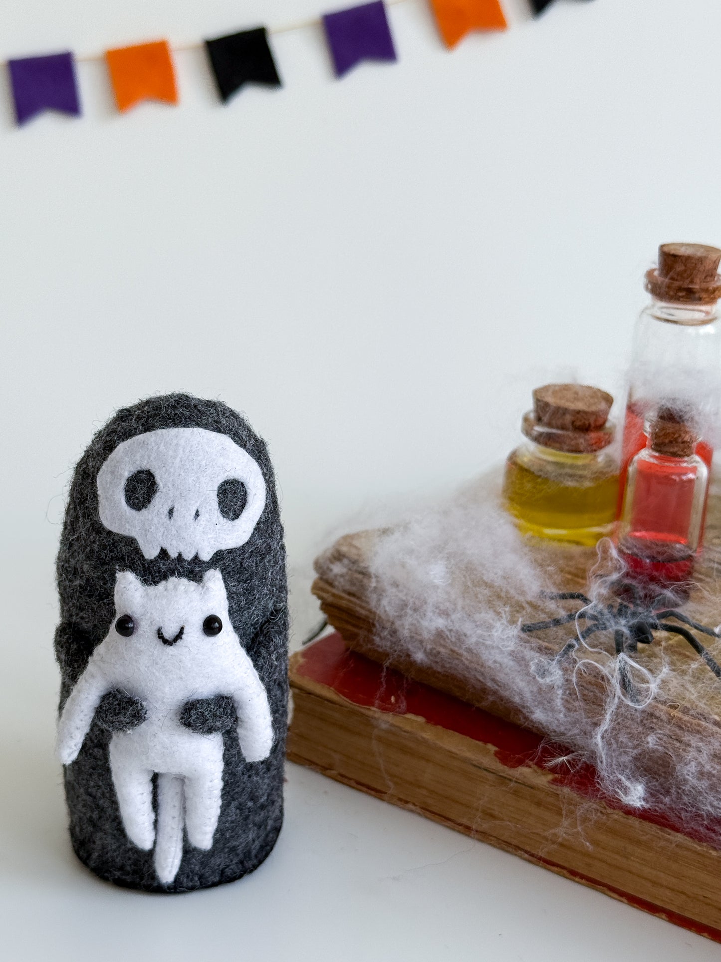 Grim Reaper felt plush holding a white cat – handmade Halloween shelf decor