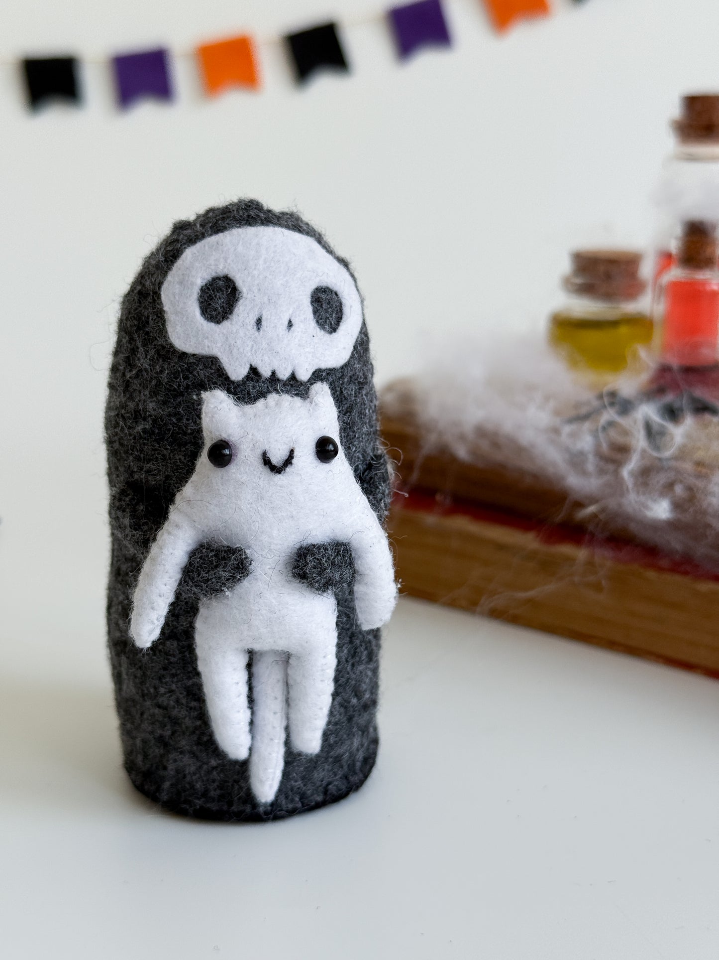 Grim Reaper felt plush holding a white cat – handmade Halloween shelf decor