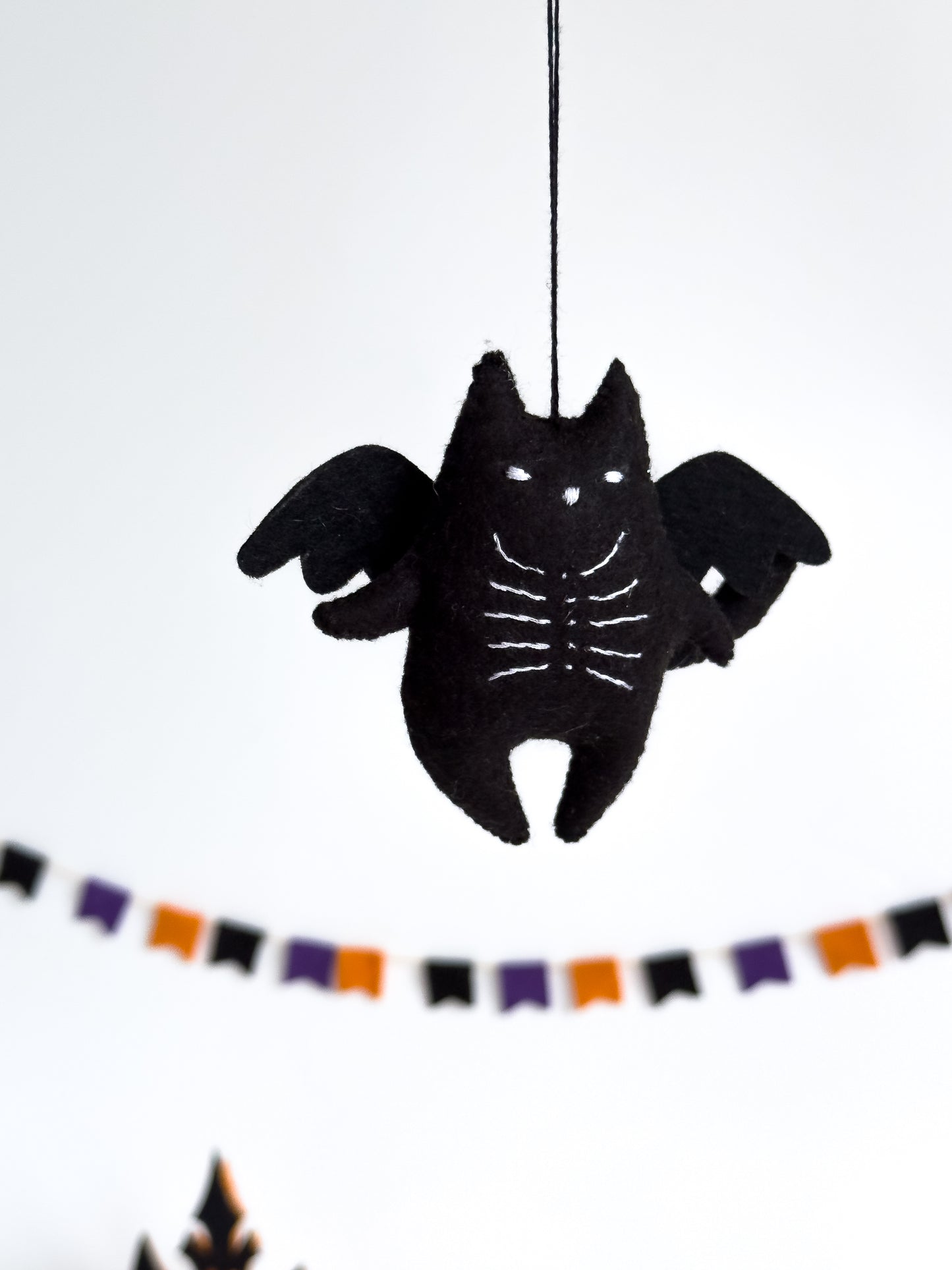Black cat with wings and skeleton chest – spooky cute decor