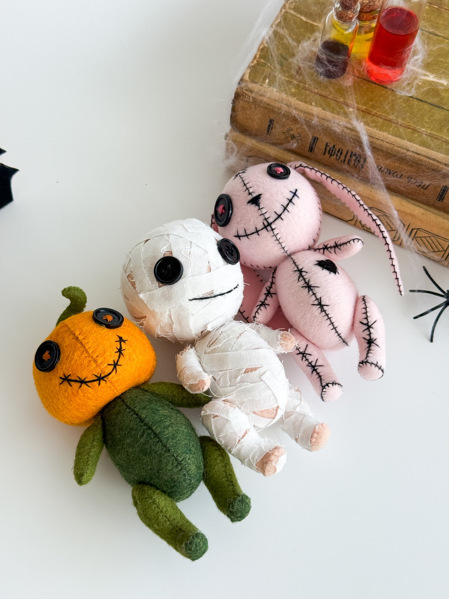 Halloween soft toy with stitched face and curly stem