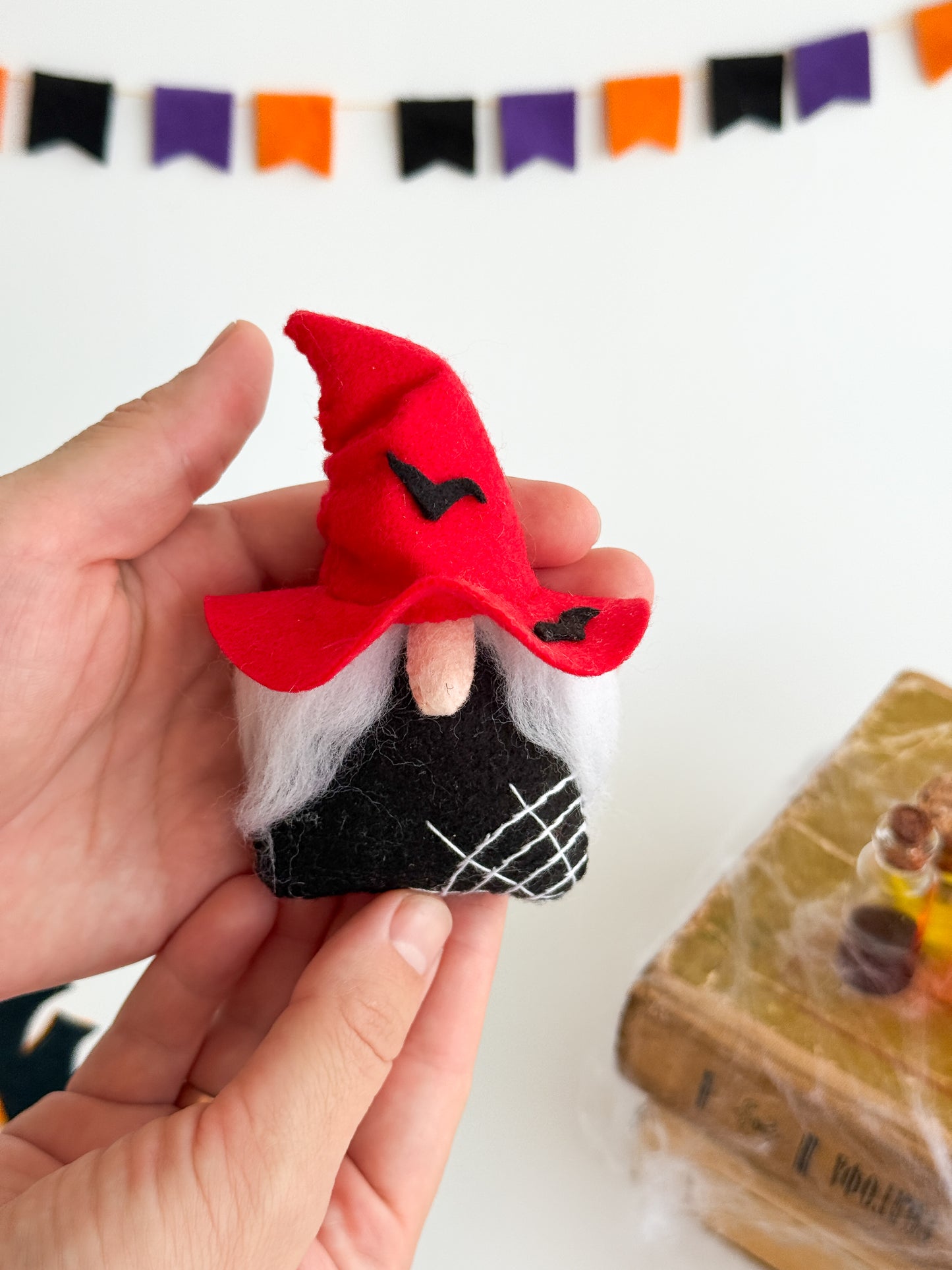 Red felt Halloween gnome with white beard and stitched details