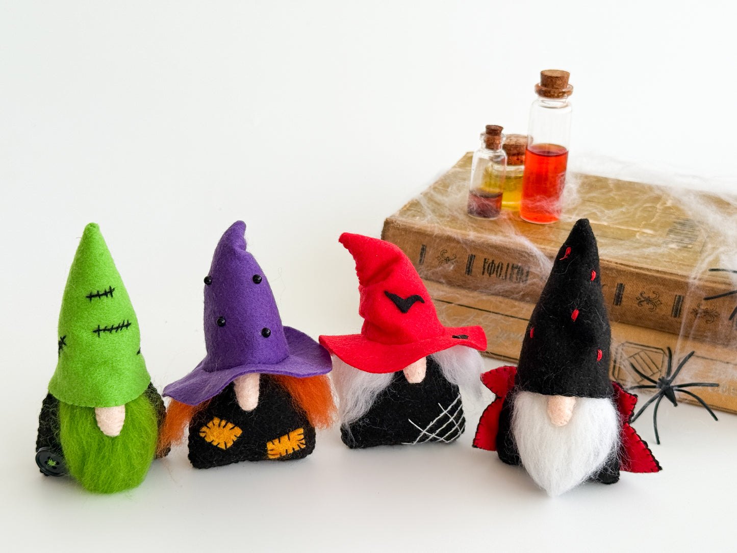 Handmade felt Halloween gnomes with colorful hats and natural wool beards