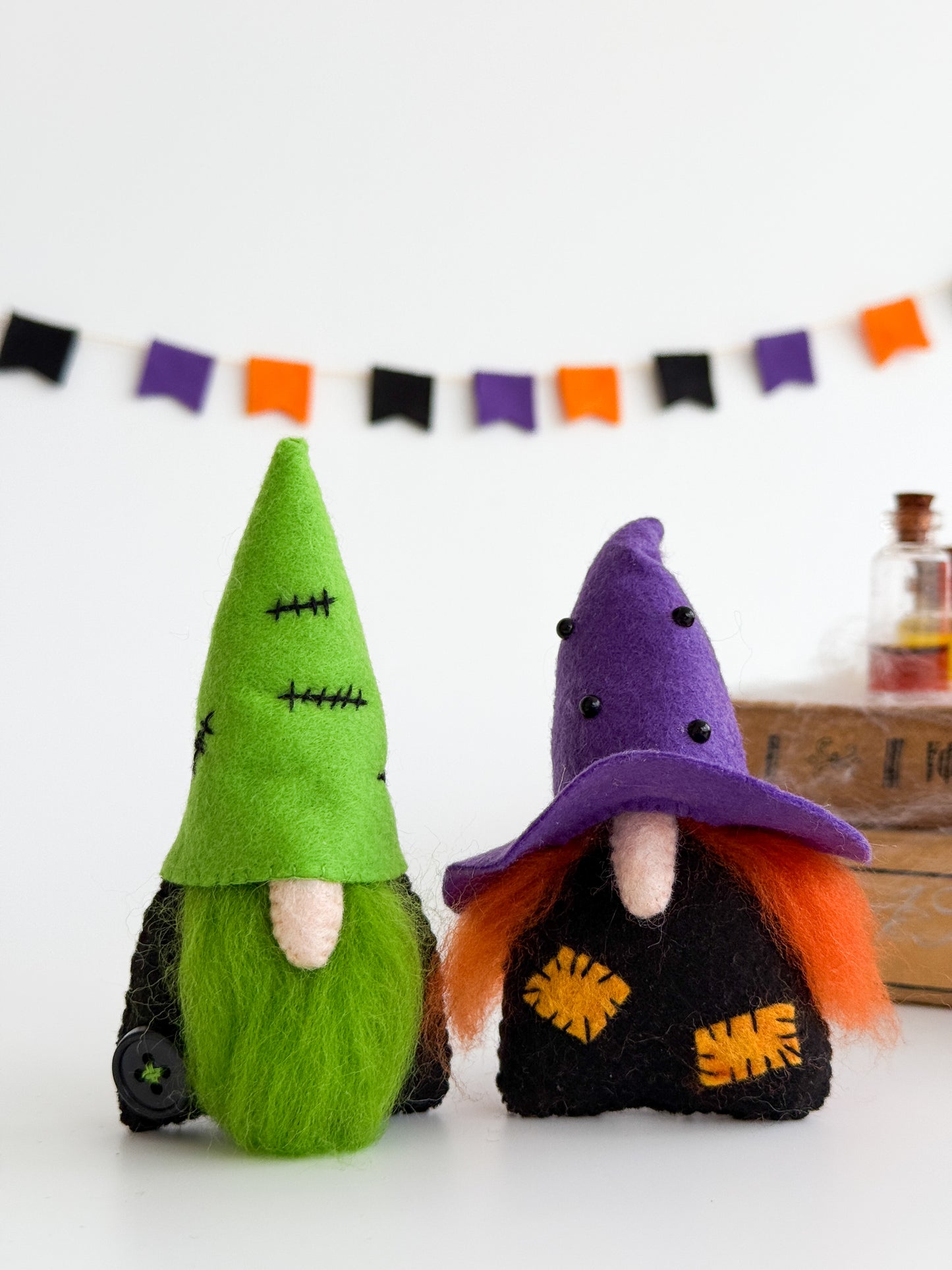 Handmade felt Halloween gnomes with colorful hats and natural wool beards