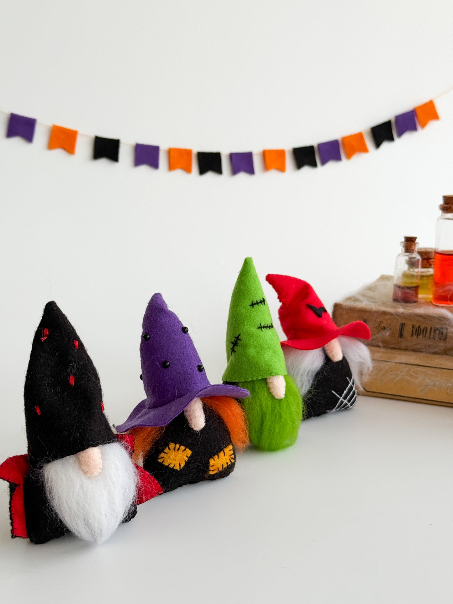 Handmade felt Halloween gnomes with colorful hats and natural wool beards