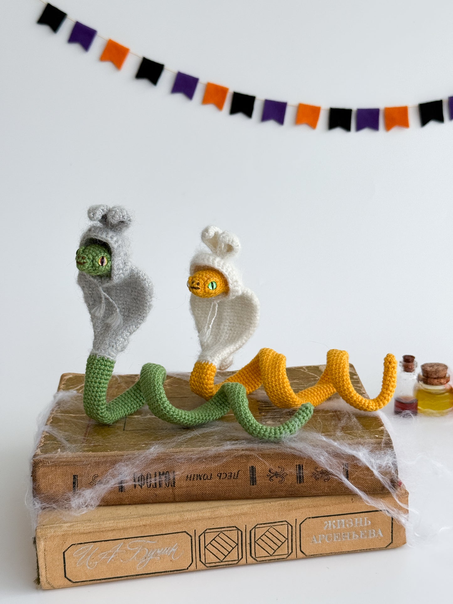 Handmade crochet snake plush dressed in bunny hoodie, cute kawaii animal toy.