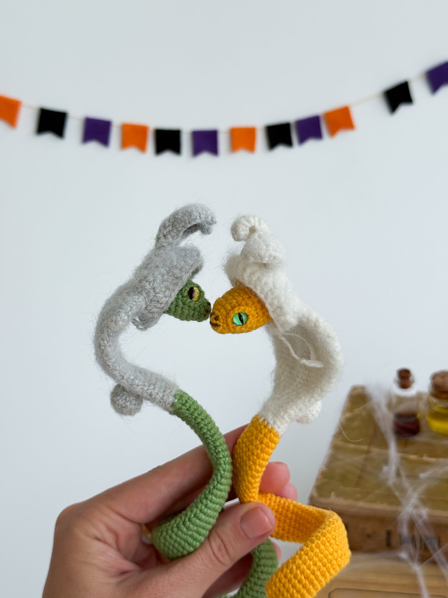 Poseable crochet snake in hoodie, soft handmade plush for collectors and gifts.