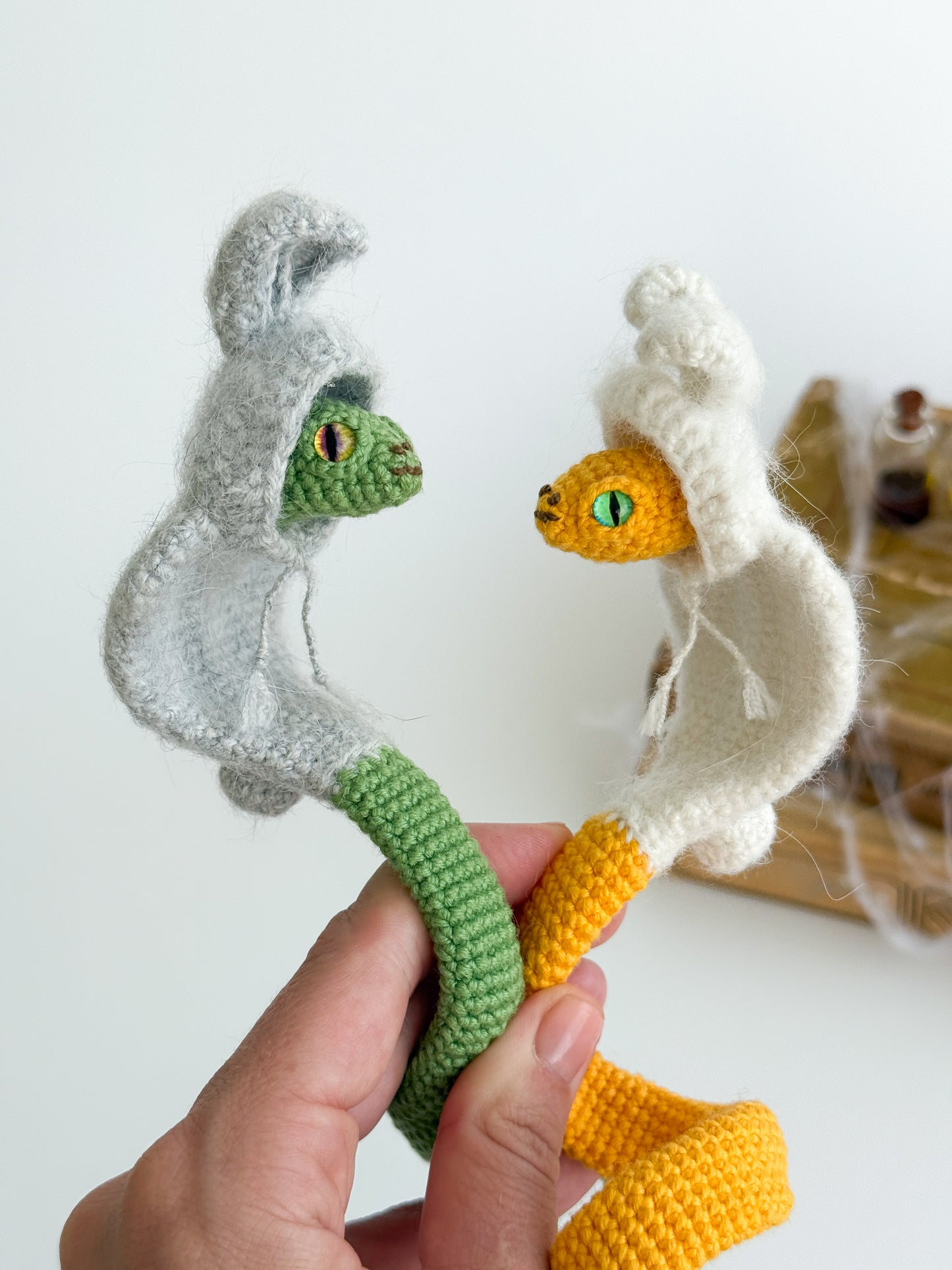 Handmade crochet cobra plush in bunny hoodie, poseable snake toy for kawaii lovers.
