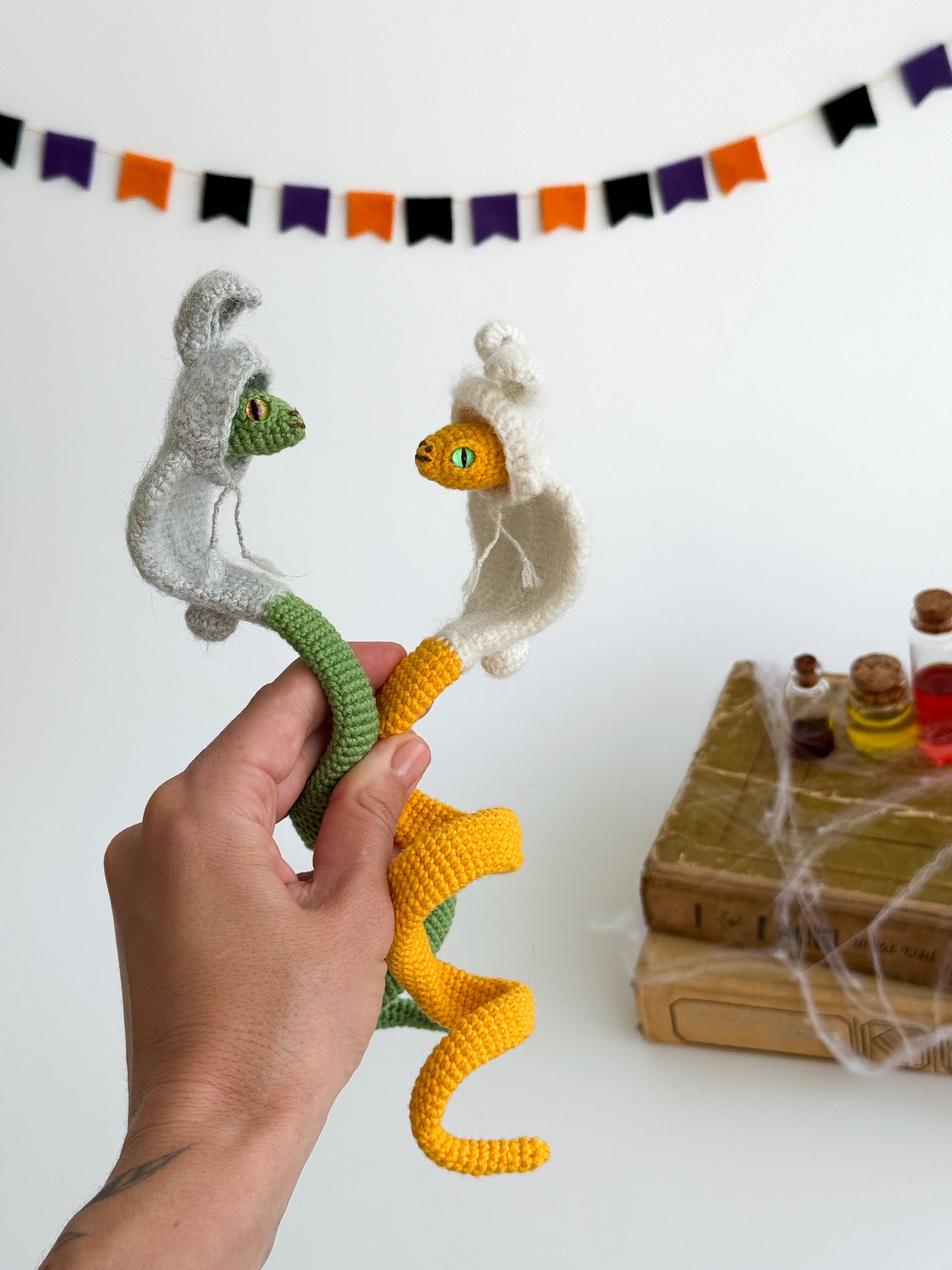 Poseable amigurumi snake in cute bunny hoodie, handmade kawaii plush gift.