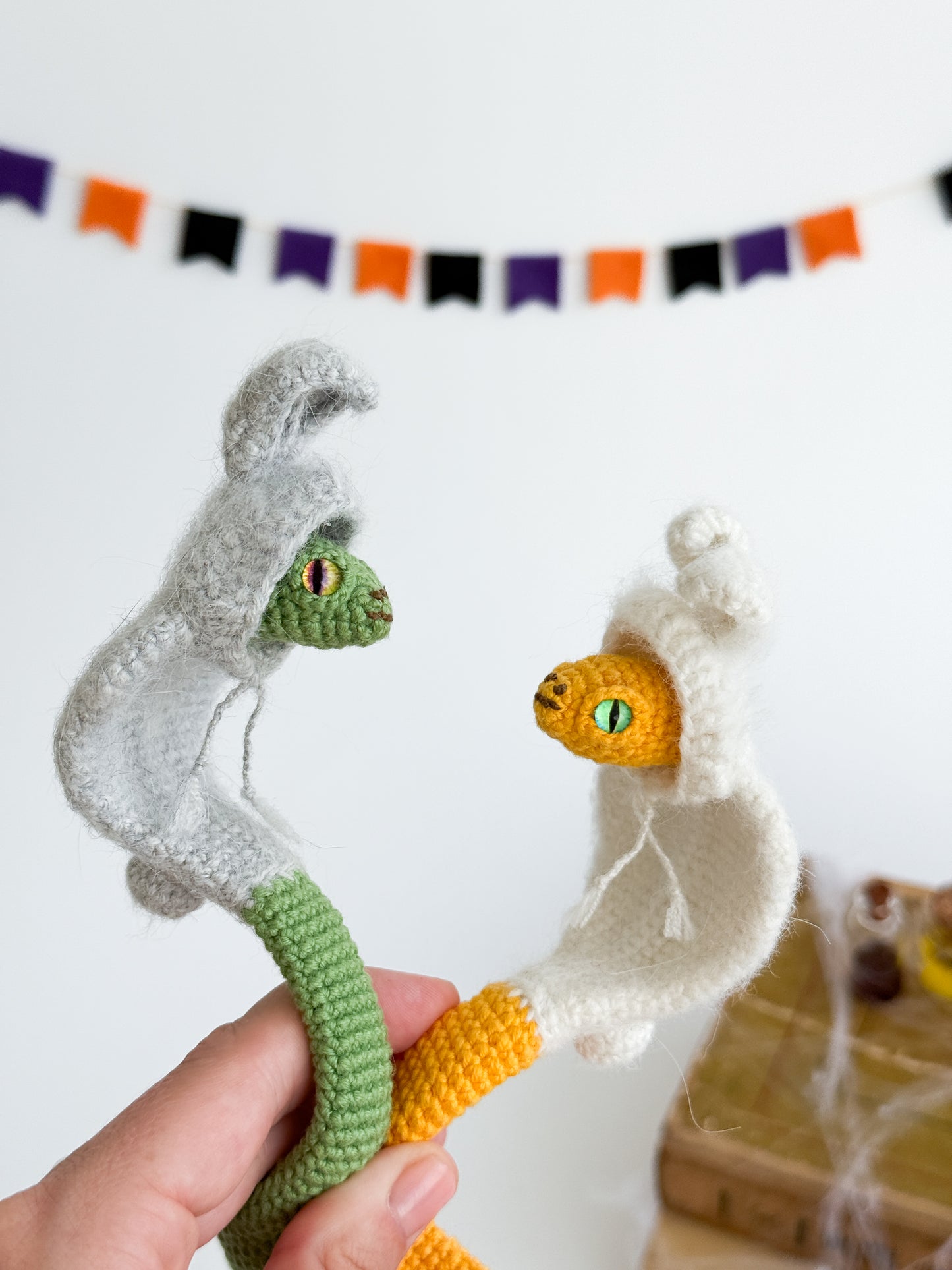 Poseable crochet snake in hoodie, soft handmade plush for collectors and gifts.