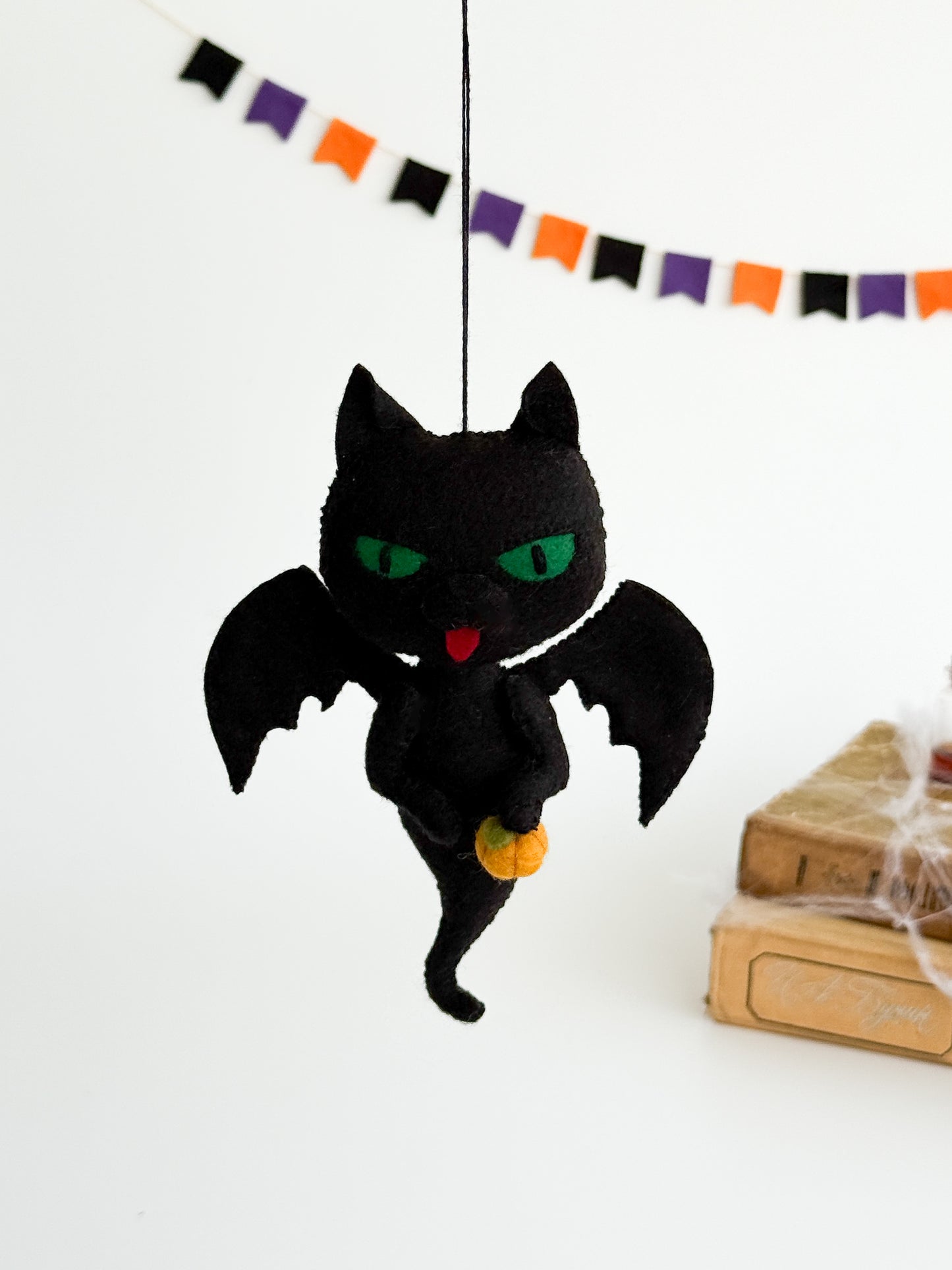Handmade felt black cat ghost with orange pumpkin, spooky cute Halloween ornament for home décor.