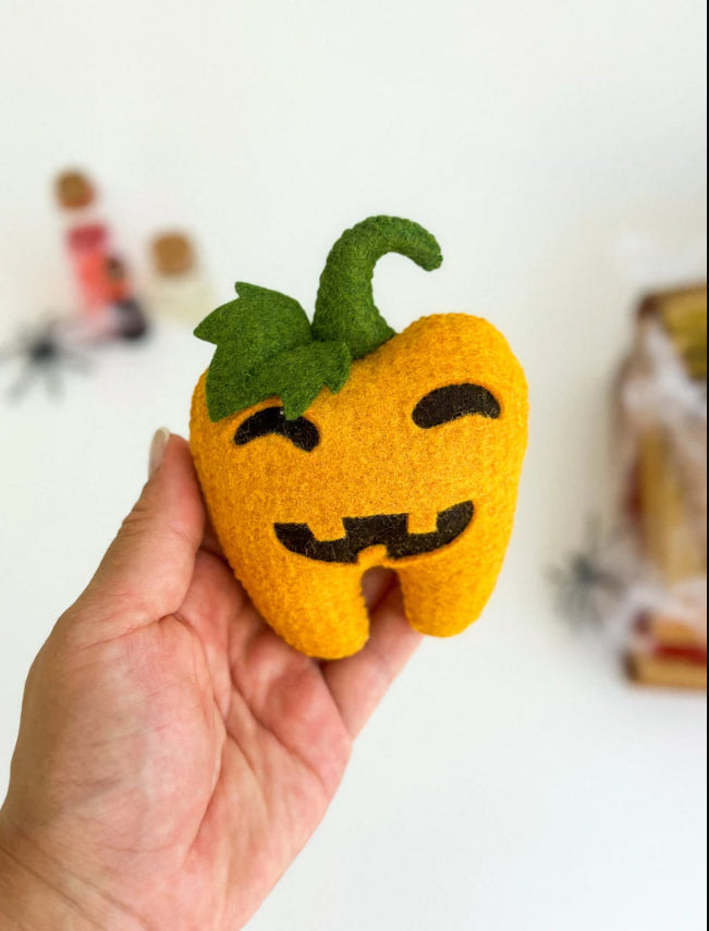 Close-up of pumpkin face on the tooth ornament