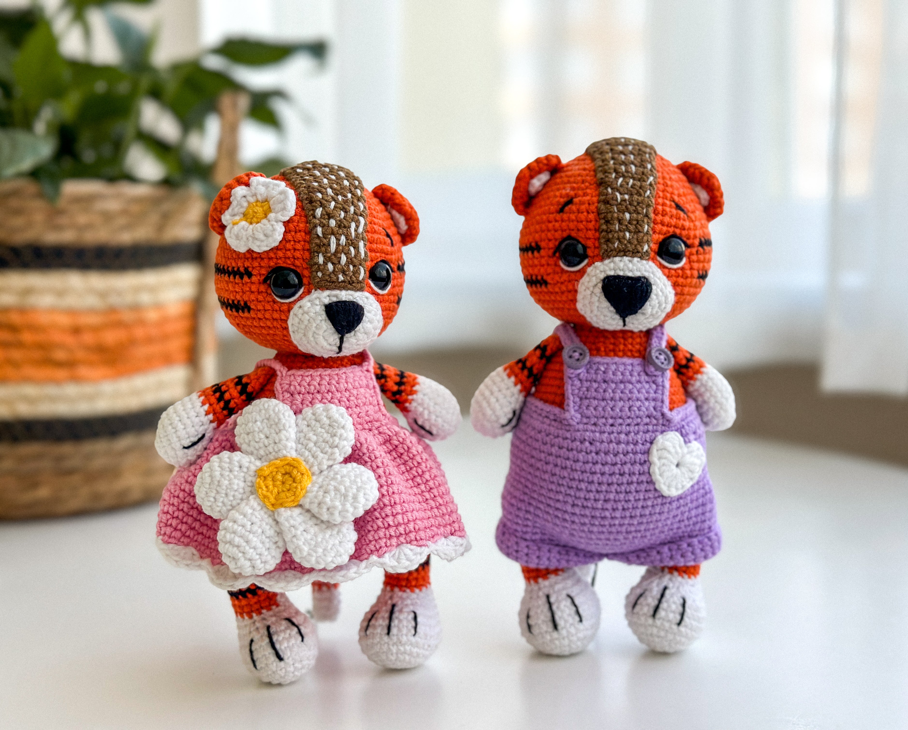 Set of handmade crochet tiger dolls – girl in pink dress and boy in overalls, amigurumi baby toys with cotton yarn