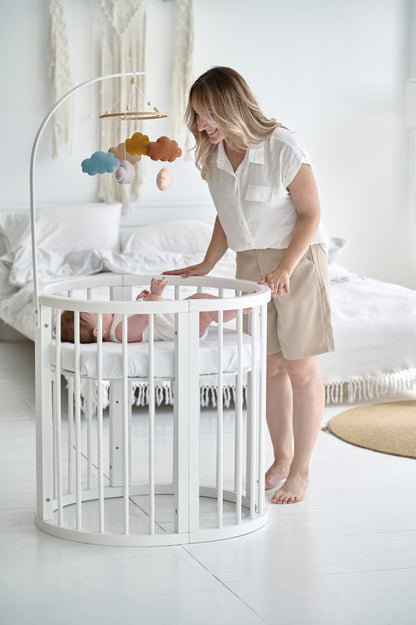 Soft and dreamy pastel cloud mobile above baby’s crib