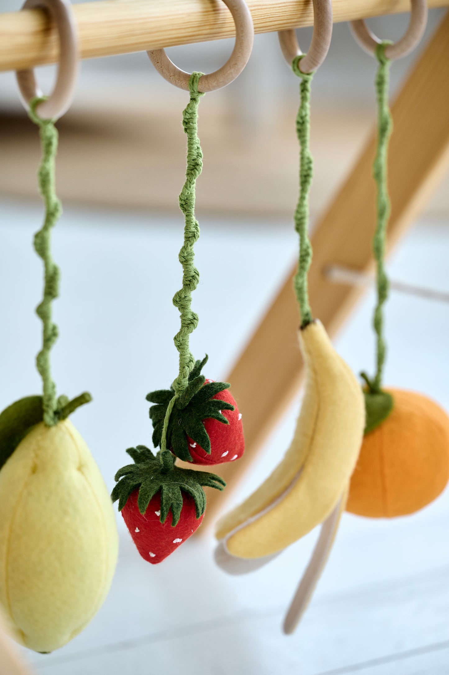 Close-up of felt fruit and cotton details – soft natural textures

