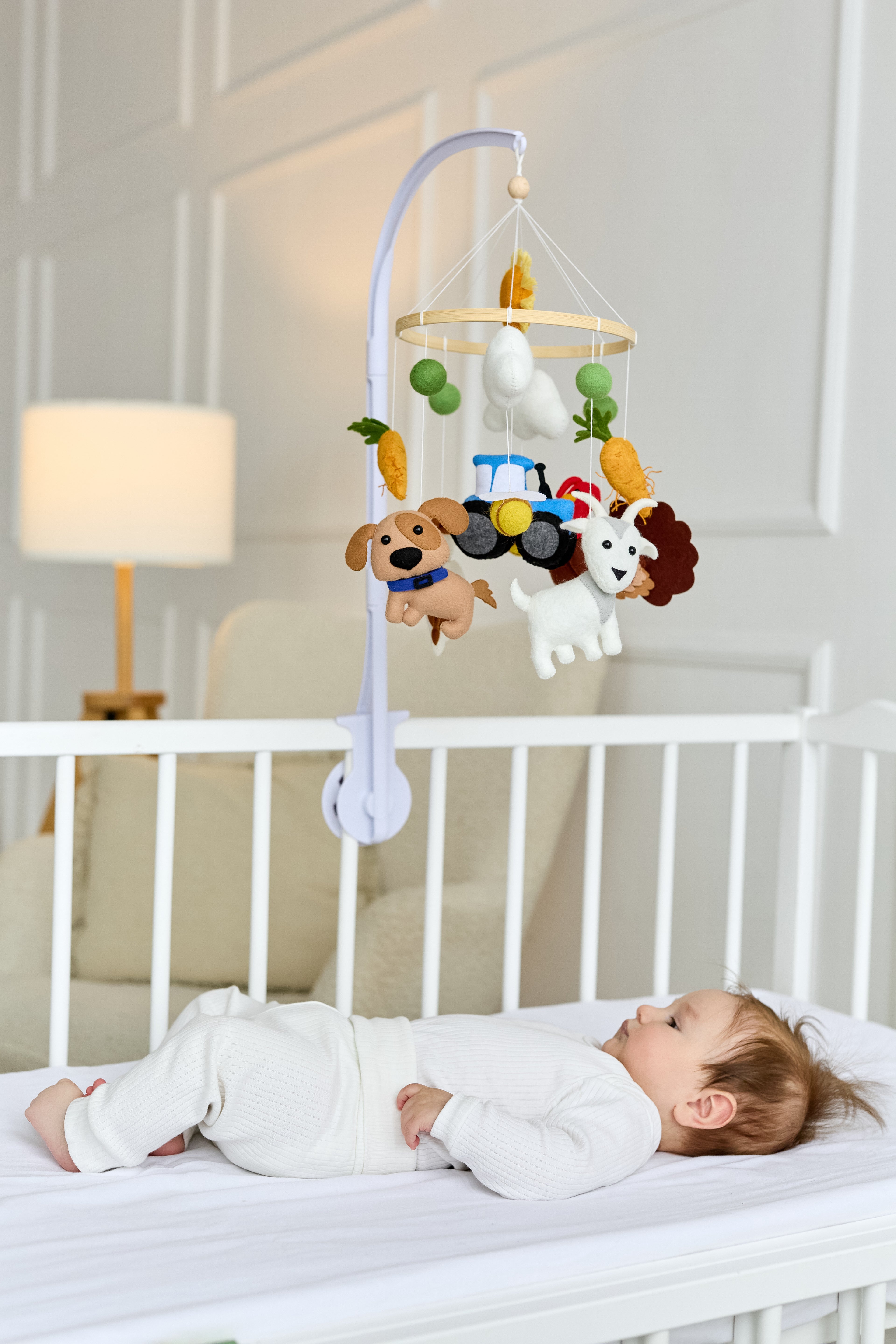 Handmade farm-themed felt baby mobile with animals and tractor