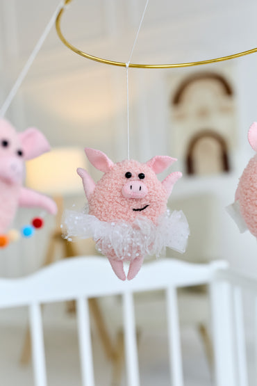 Close-up of a felt piglet from nursery mobile, baby shower decor