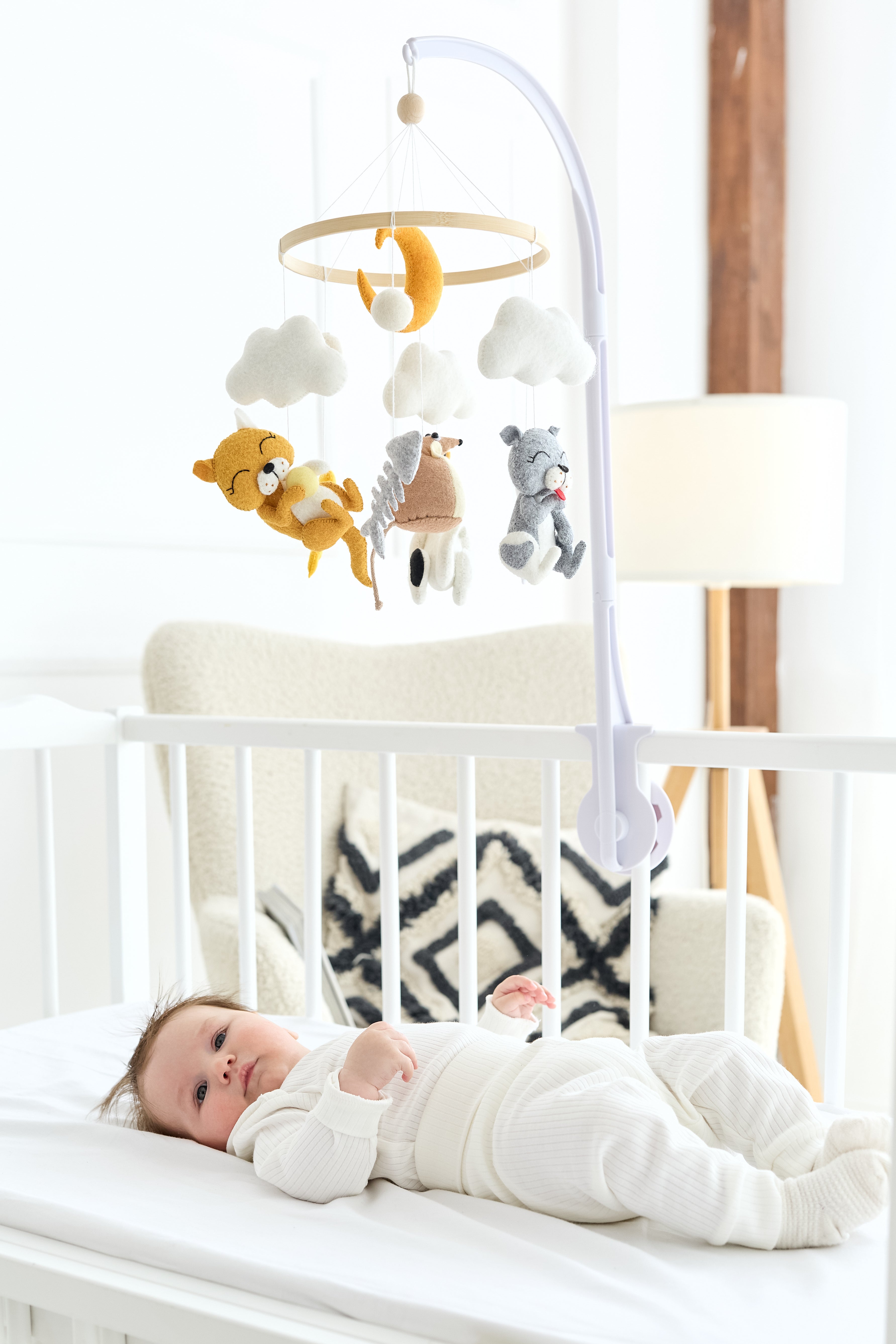 Felt kitten baby mobile with mouse hanging above crib