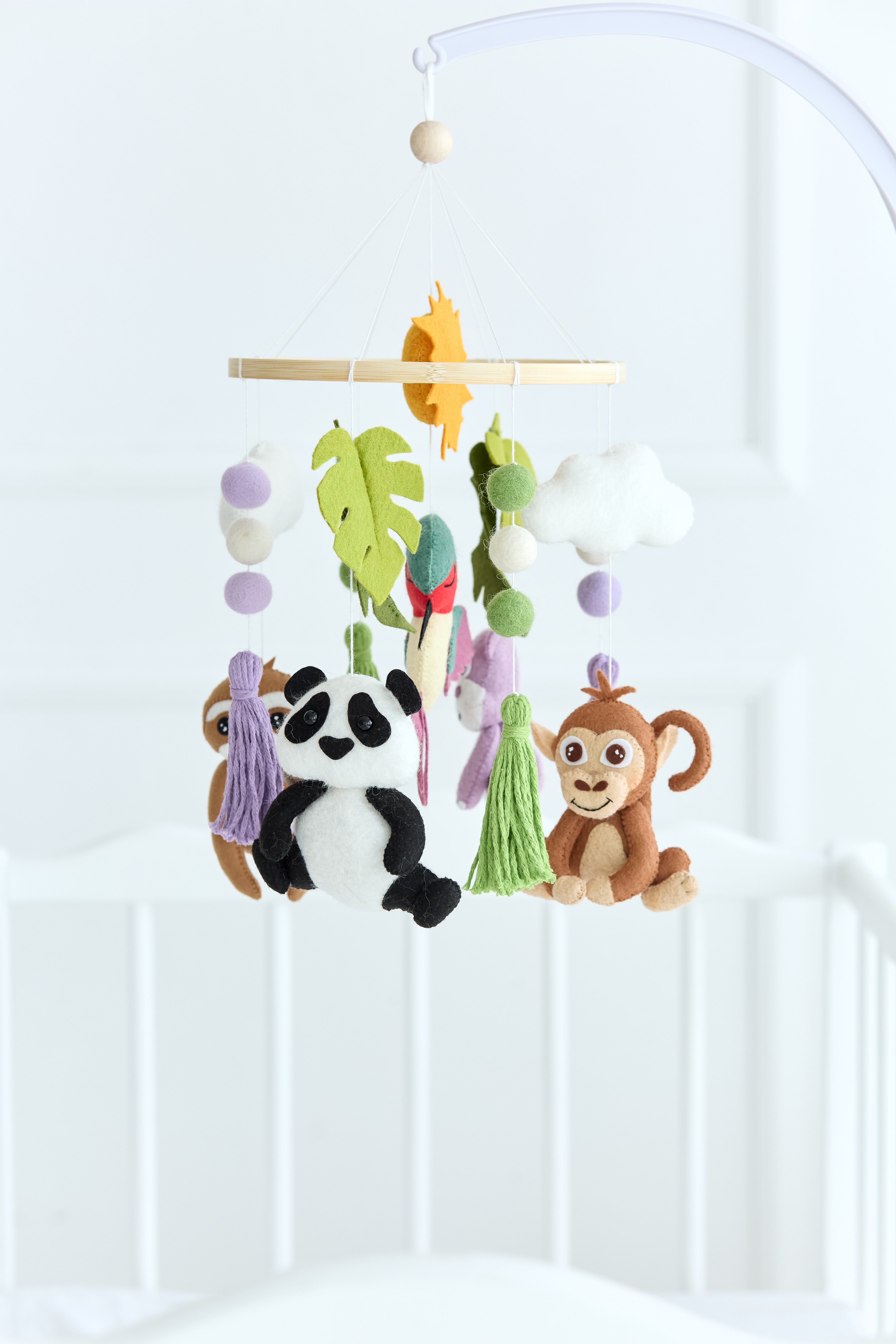 Felt baby mobile with panda, monkey, sloth, and hippo animals on a wooden ring

