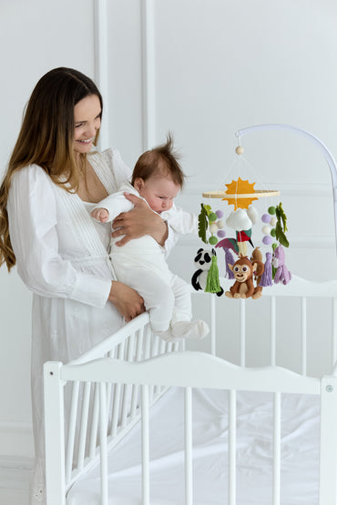 Jungle-themed baby mobile with wool balls, tassels, and felt animals for crib
