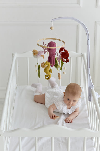 Turtle, crab, and fish hanging on wooden baby mobile