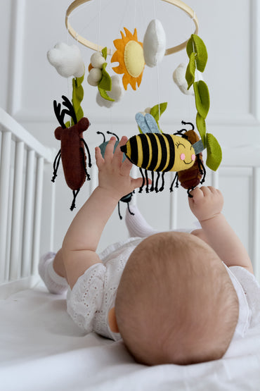 Handmade insect crib mobile in soft pastel colors