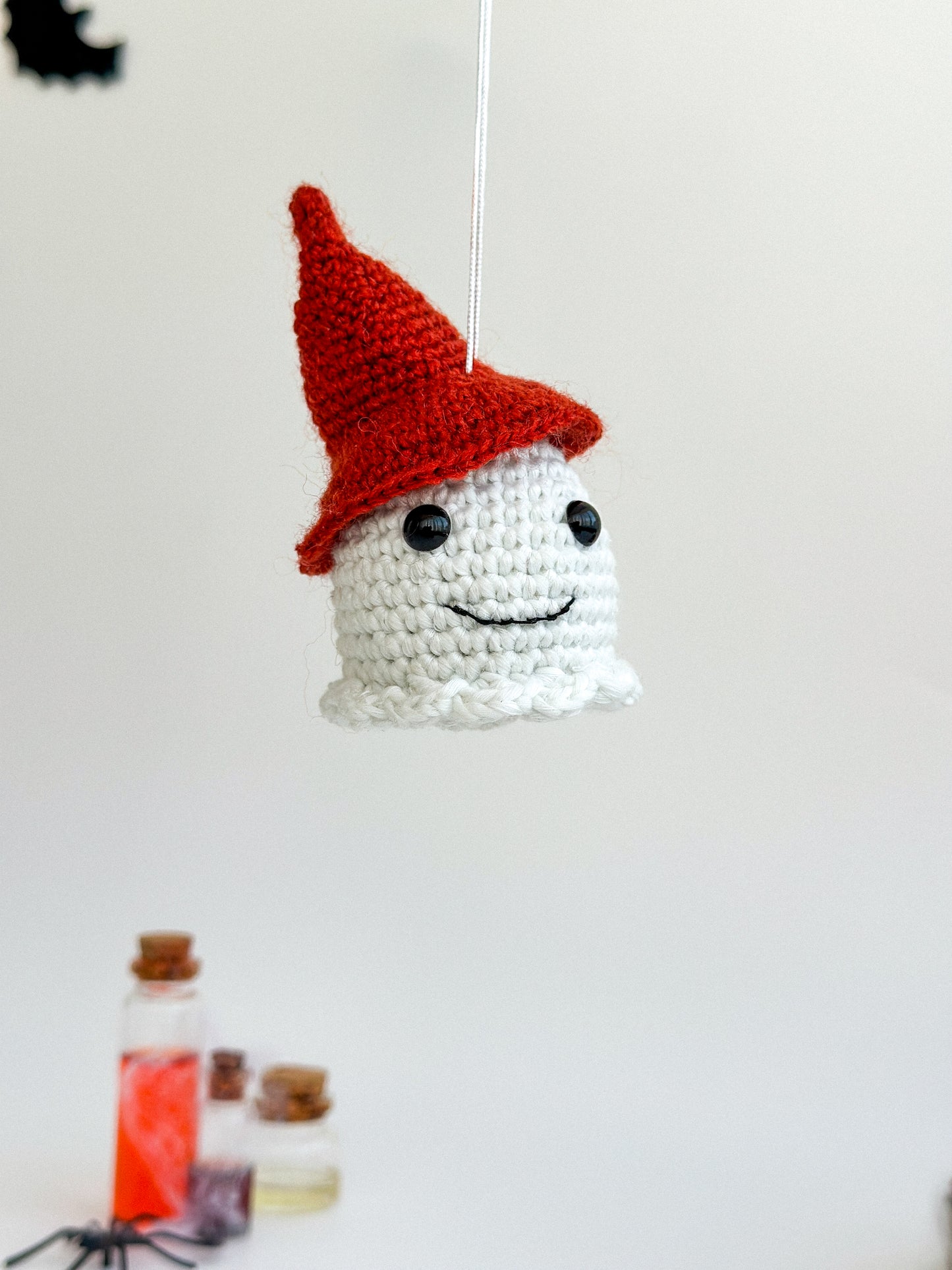 Cute amigurumi ghost car charm glowing at night