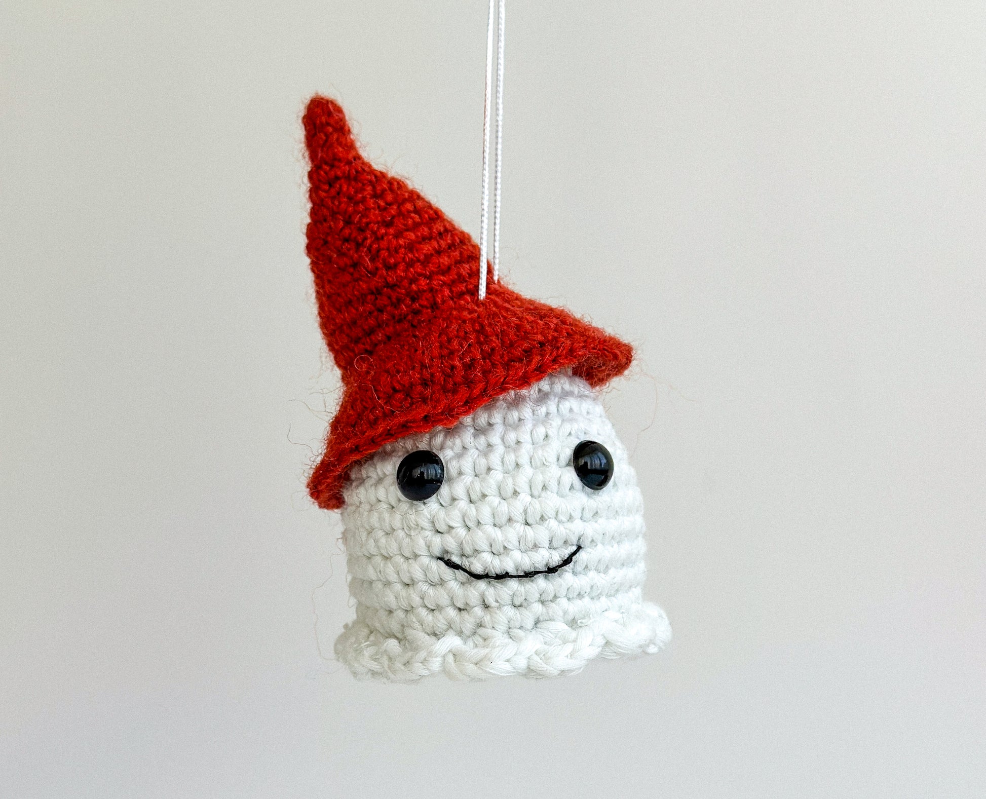 Cute amigurumi ghost car charm glowing at night