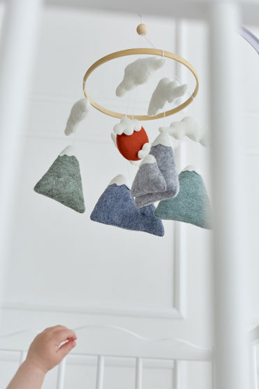 Handmade baby mobile with clouds and wooden hoop