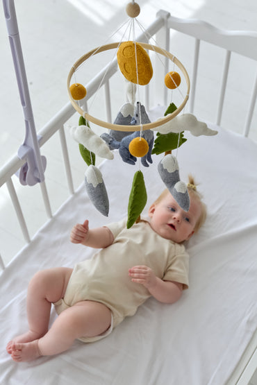 Forest-themed nursery mobile with wolf and mountains