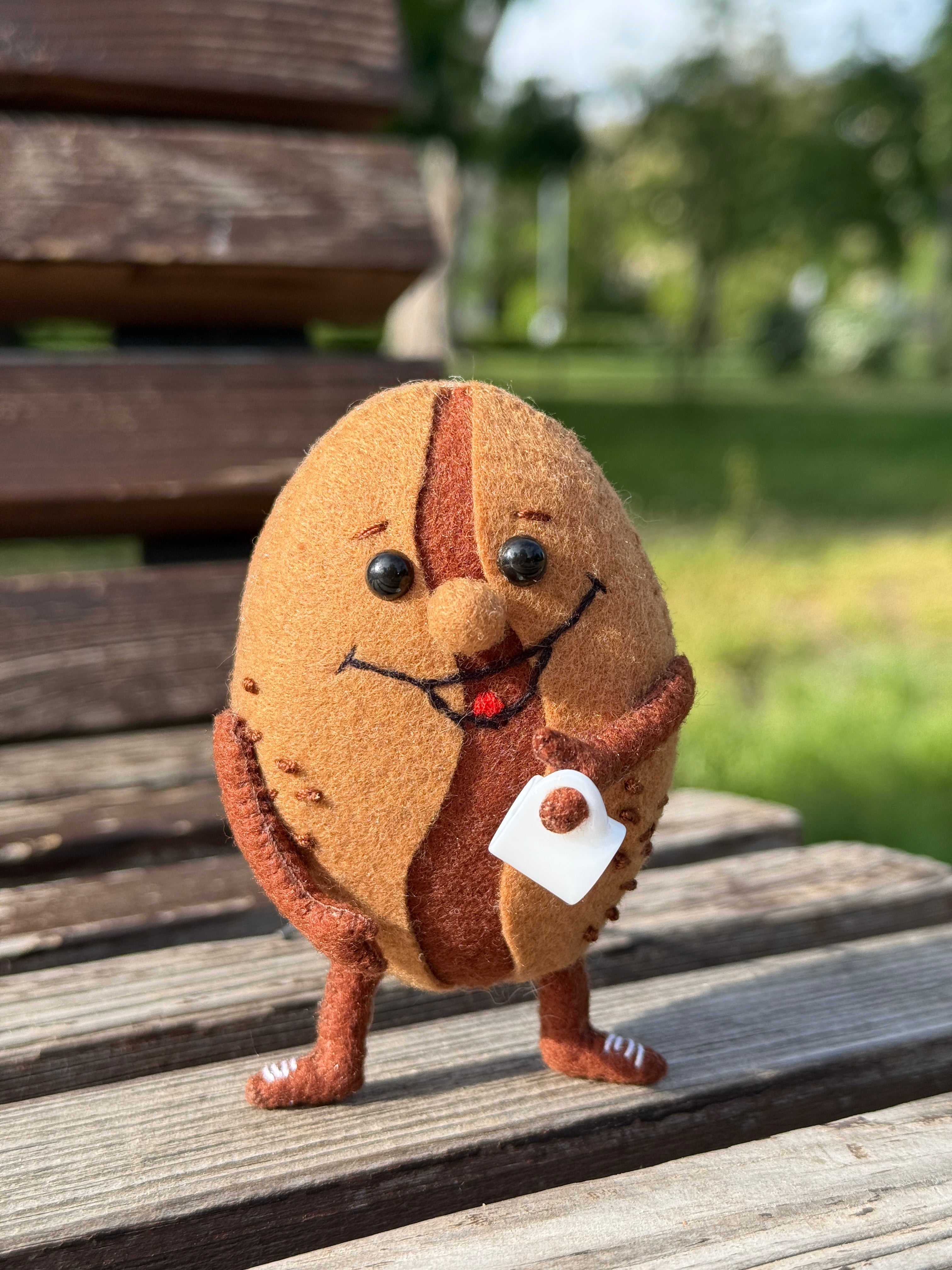 Handmade smiling felt coffee bean plush toy with tiny cup