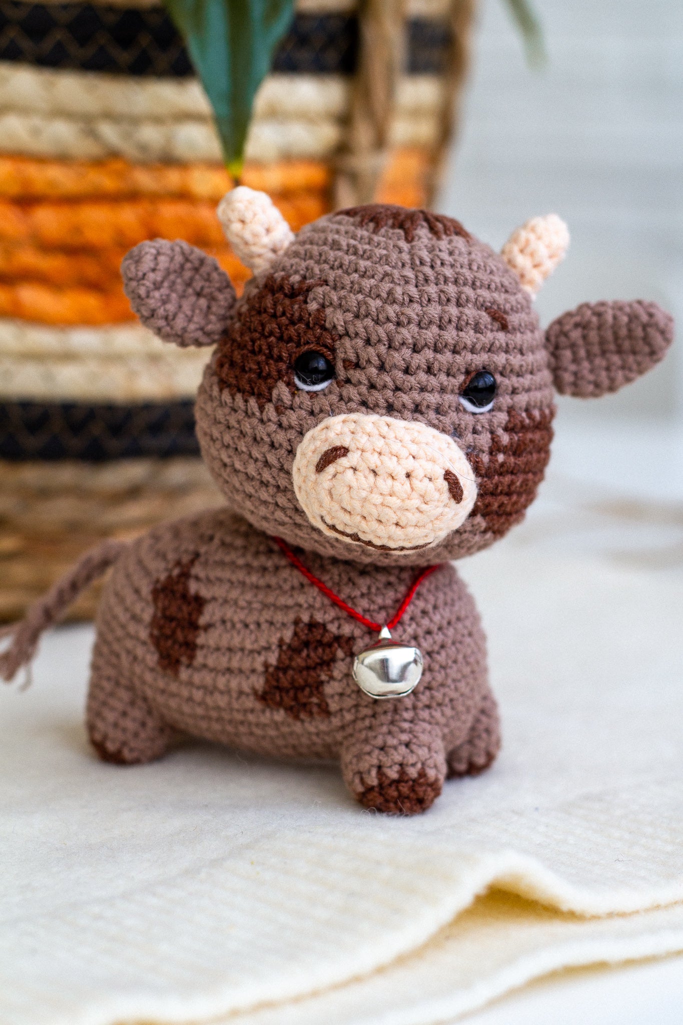 Close-up of crochet bull with neck bell – baby-safe soft animal