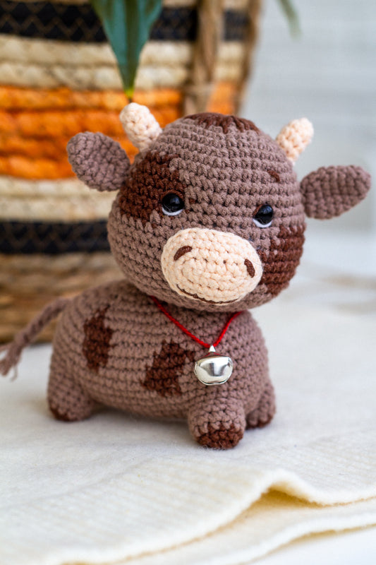 Close-up of crochet bull with neck bell – baby-safe soft animal