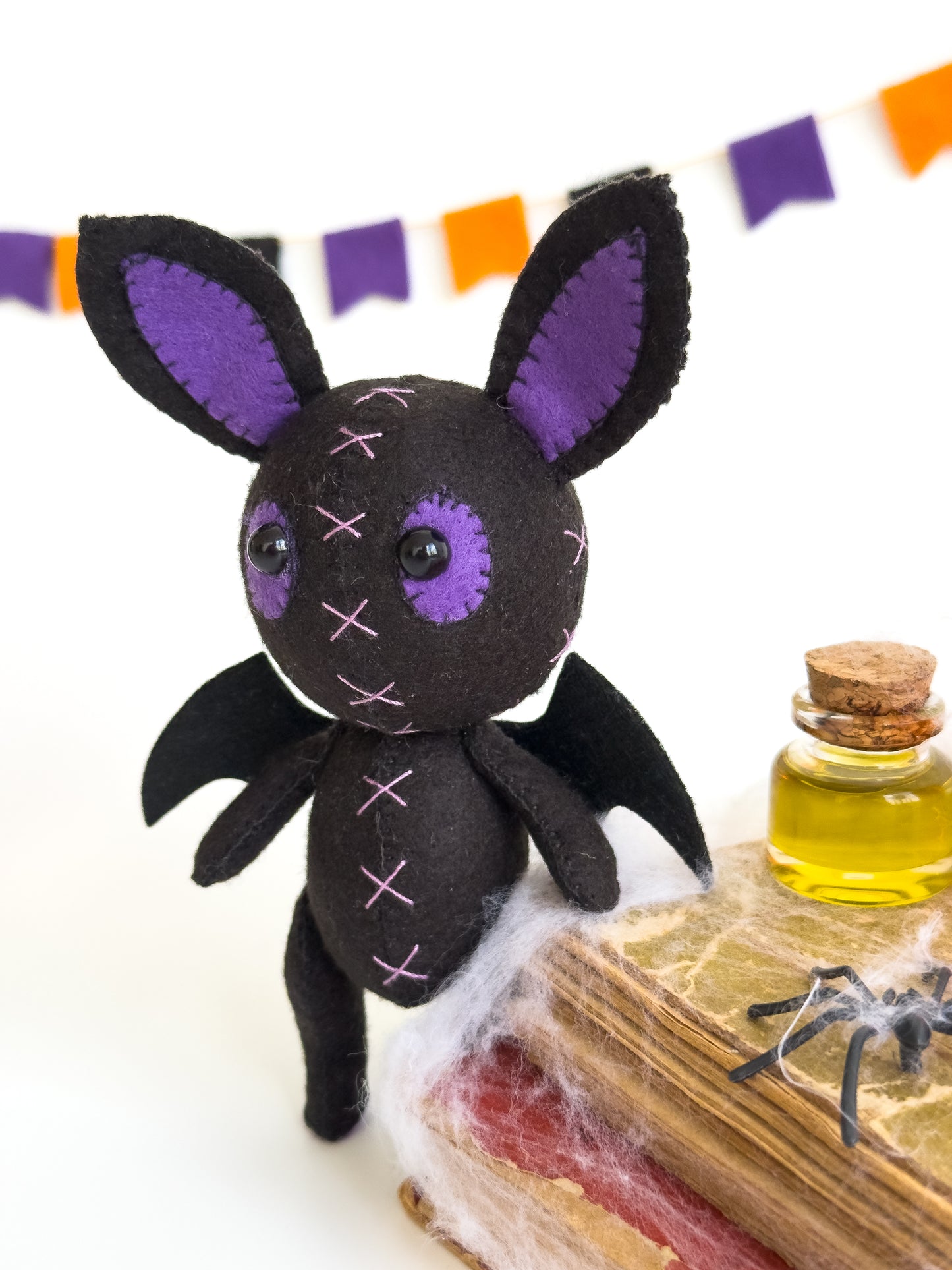 Spooky bat plush toy with purple and black felt design