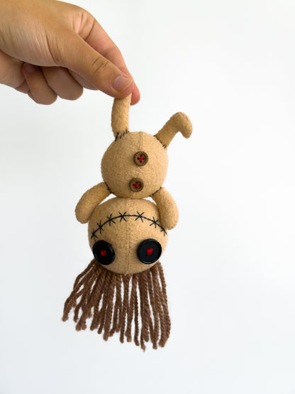 Creepy cute voodoo felt doll with button eyes and yarn hair


