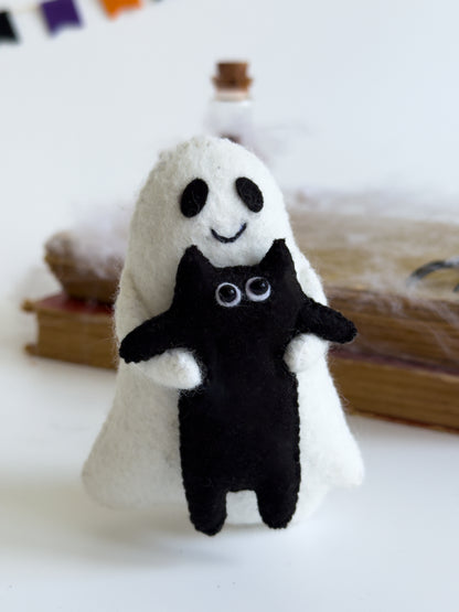 Ghost plush toy with stitched smile and hugging black kitty