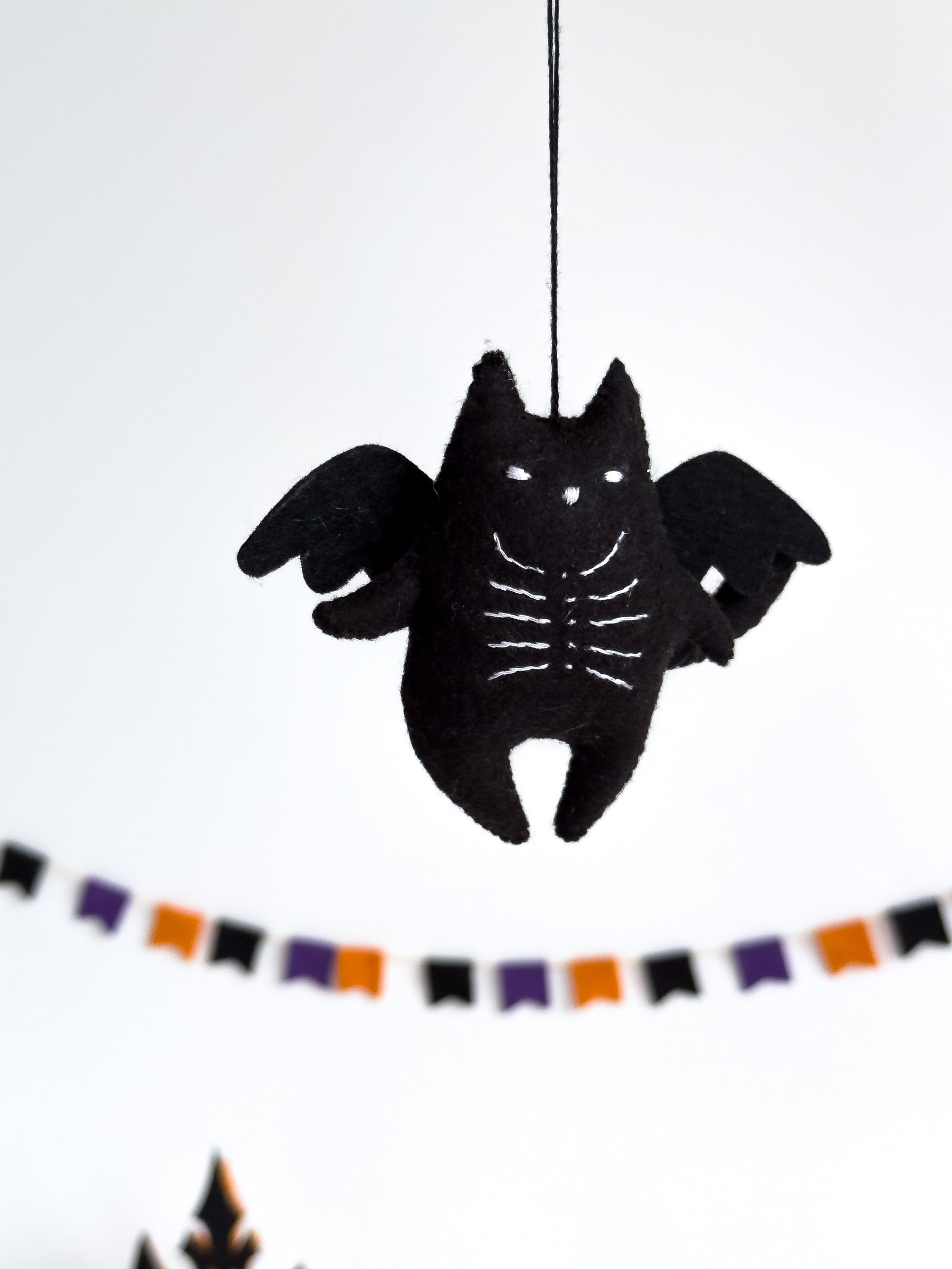 Black cat with wings and skeleton chest – spooky cute decor